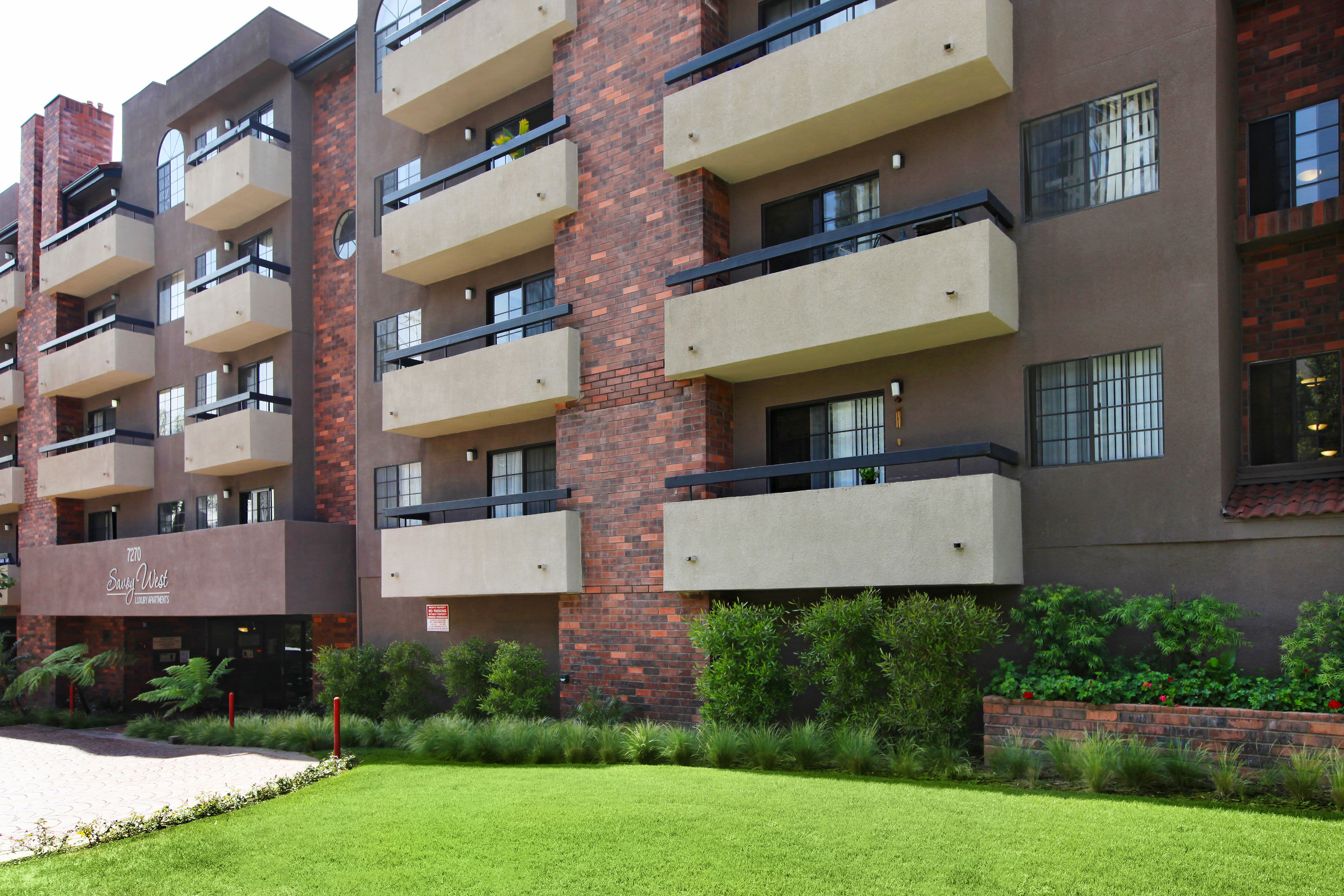 Exterior with green lawn at Savoy West Apartments in Los Angeles, California