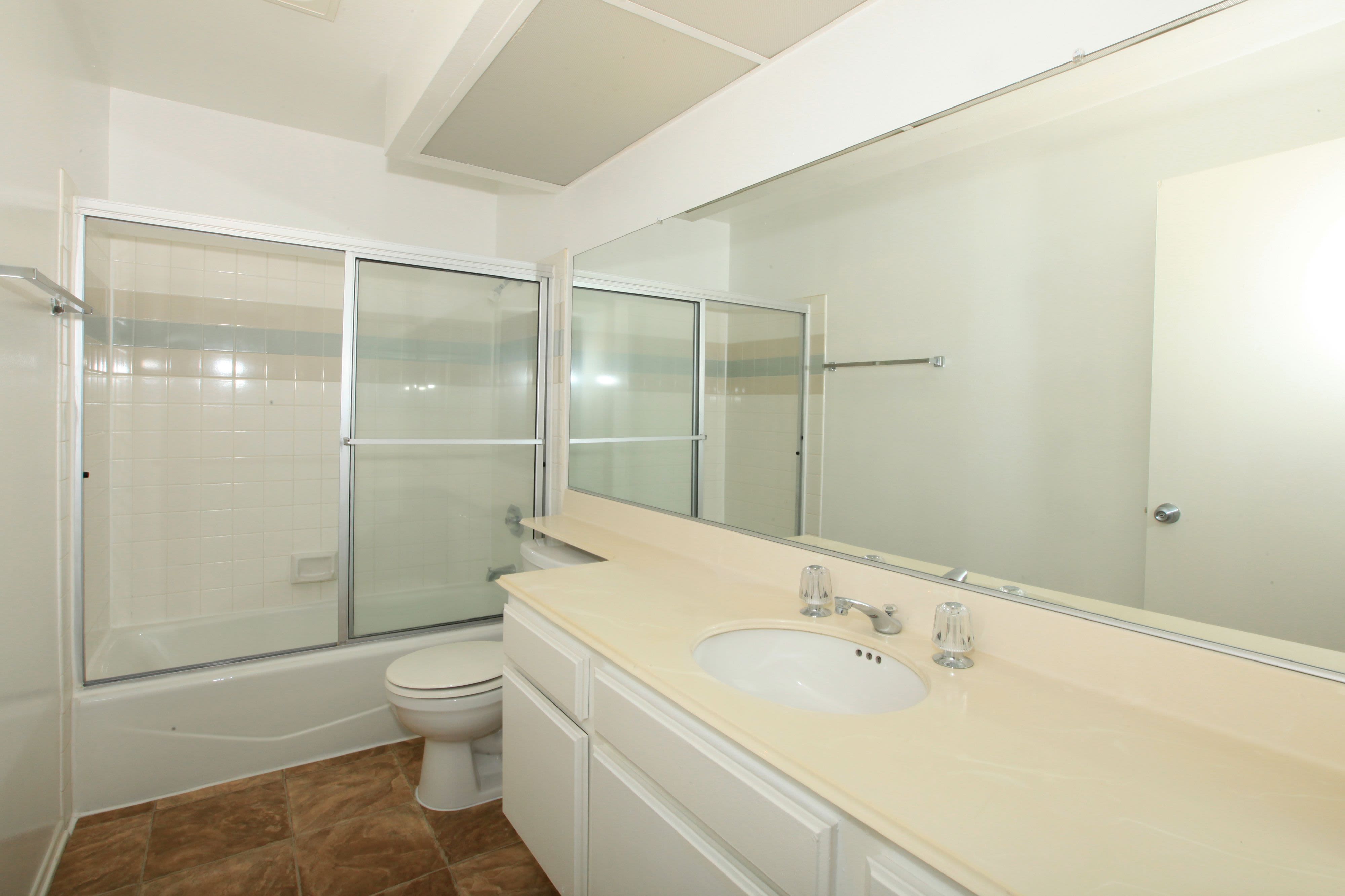 Model bathroom with tub and shower at Savoy West Apartments in Los Angeles, California