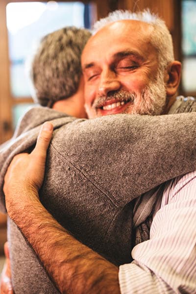 Seniors embracing at Heritage Heights in Chelan, Washington