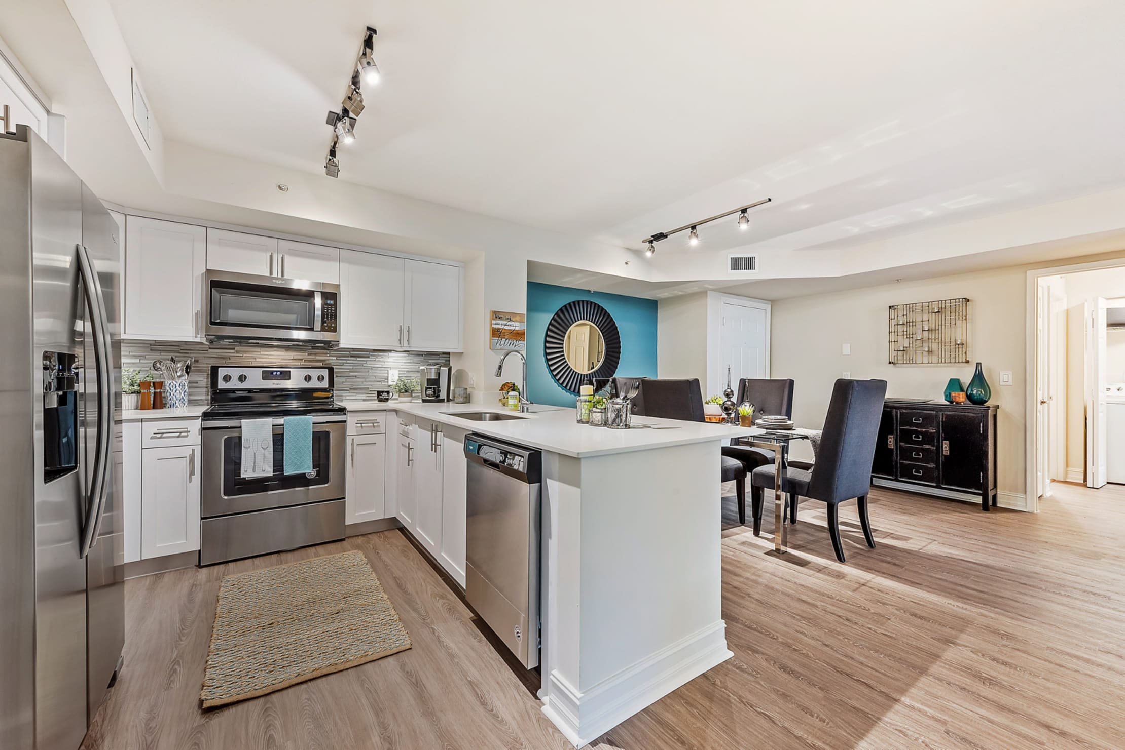 Spacious open concept kitchen and dining area in a luxury apartment home at Crescent House Apartments in Miami Lakes, Florida