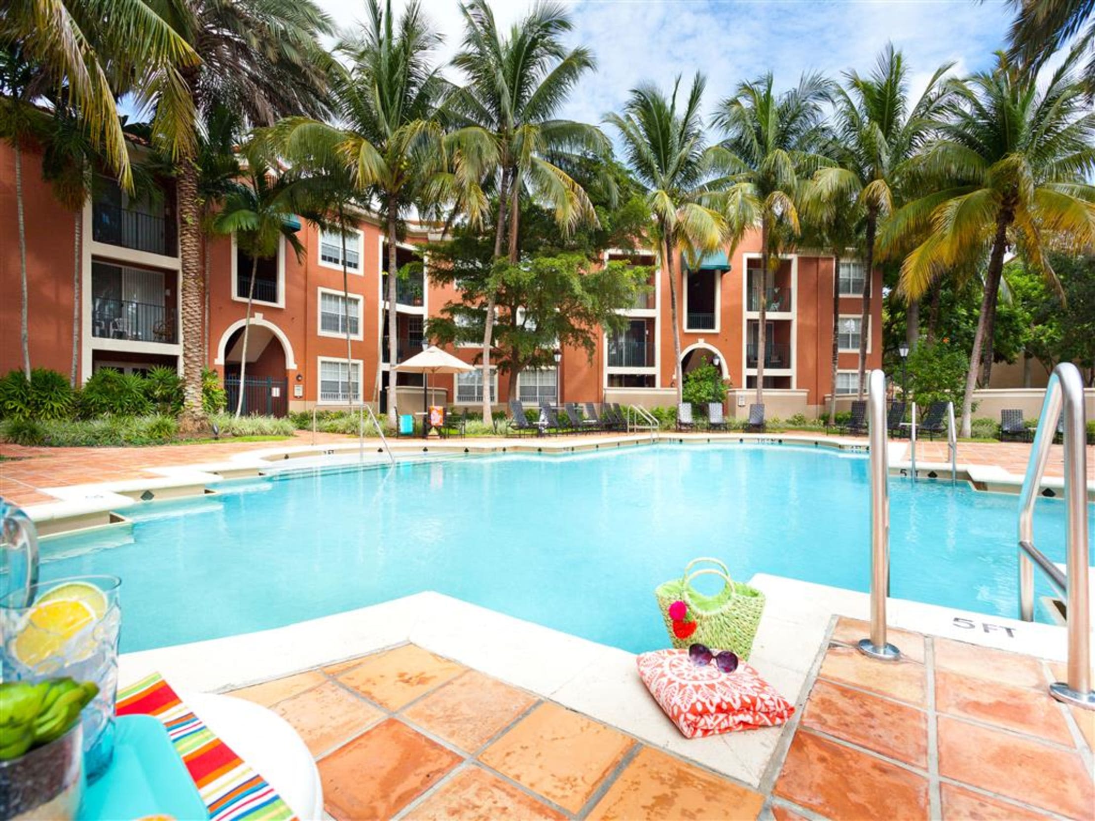 Resort-style swimming pool with Spanish tile deck at Crescent House Apartments in Miami Lakes, Florida