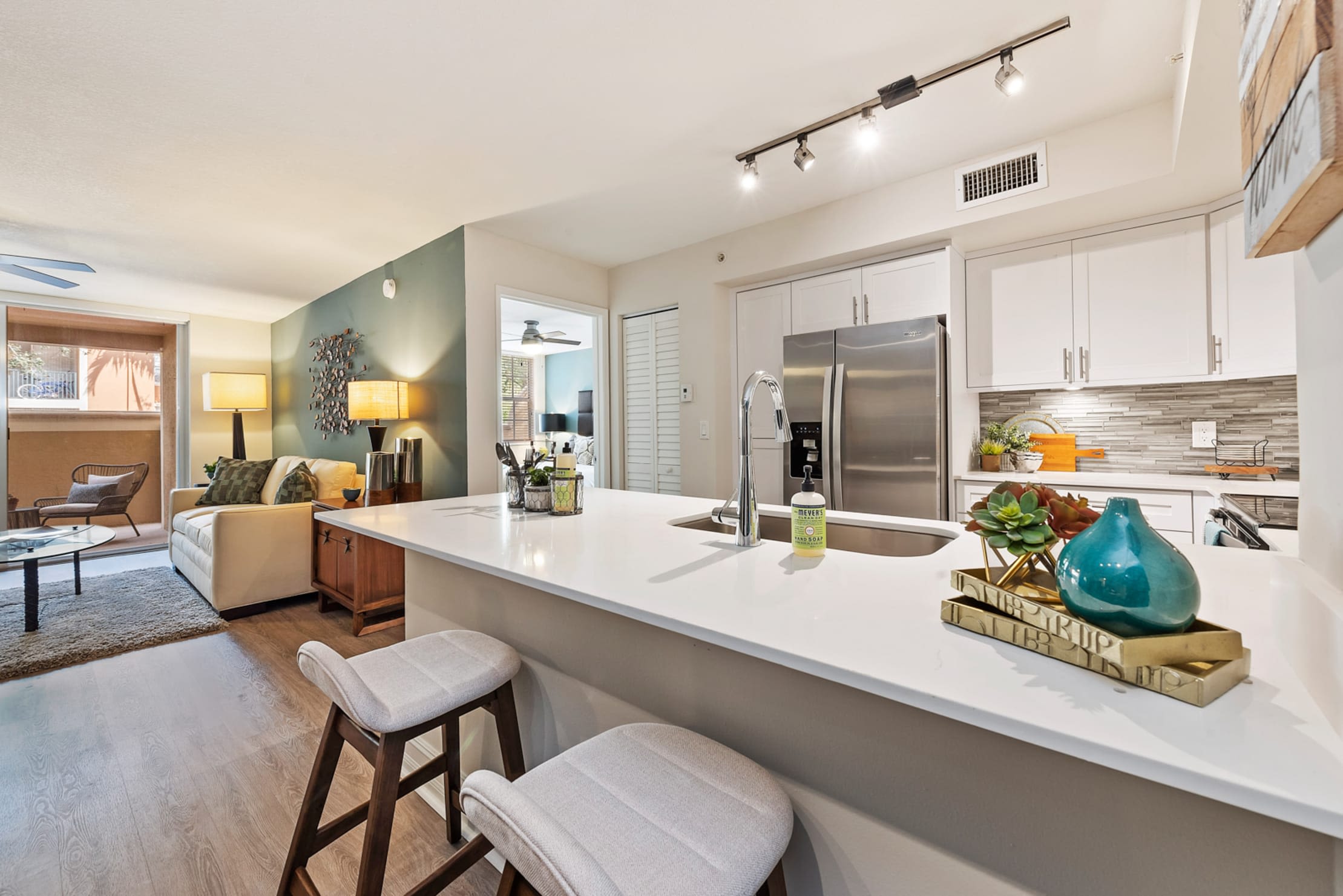 Model kitchen with countertop seating at Crescent House Apartments in Miami Lakes, Florida
