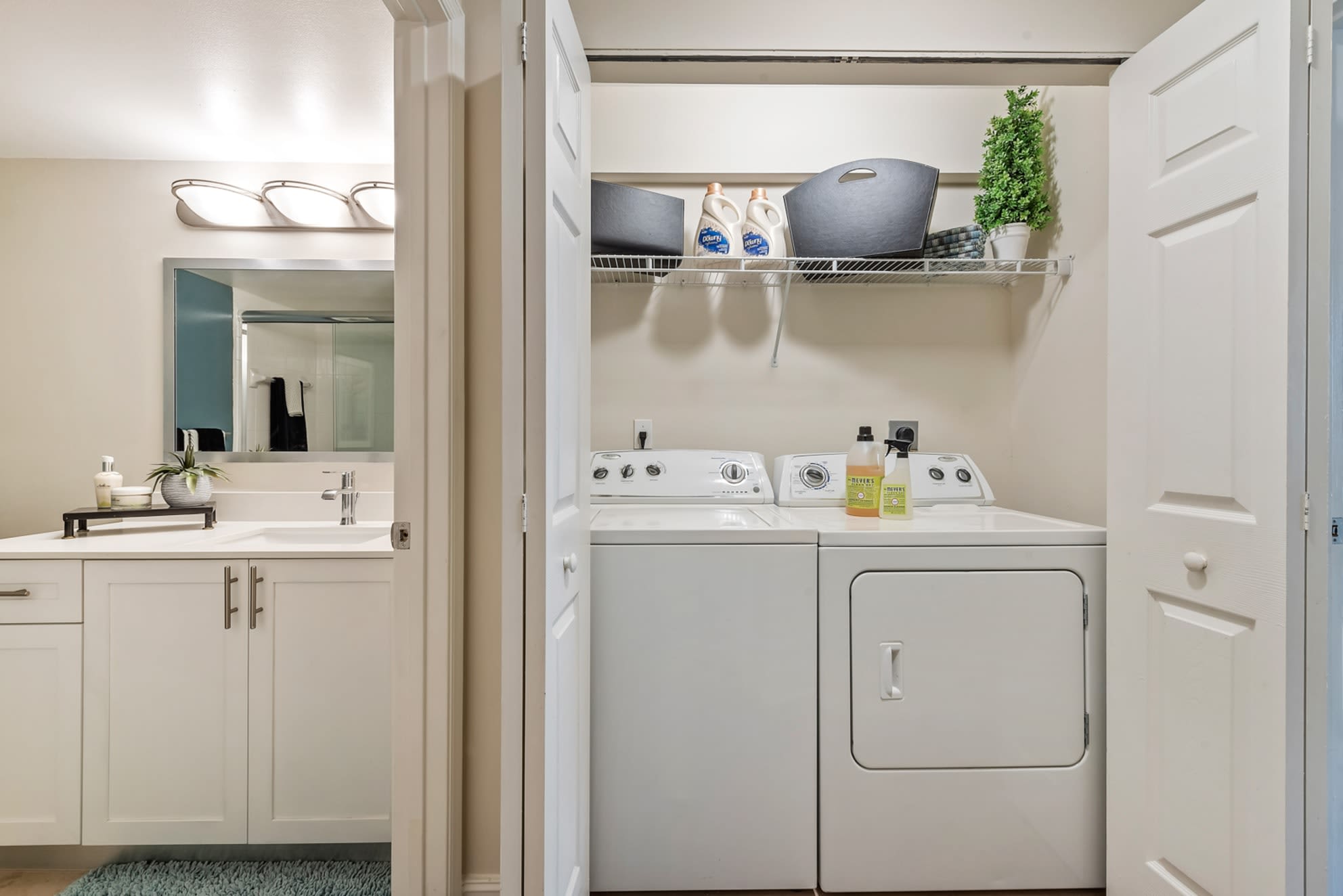 Private washer and dryer with shelving at Crescent House Apartments in Miami Lakes, Florida