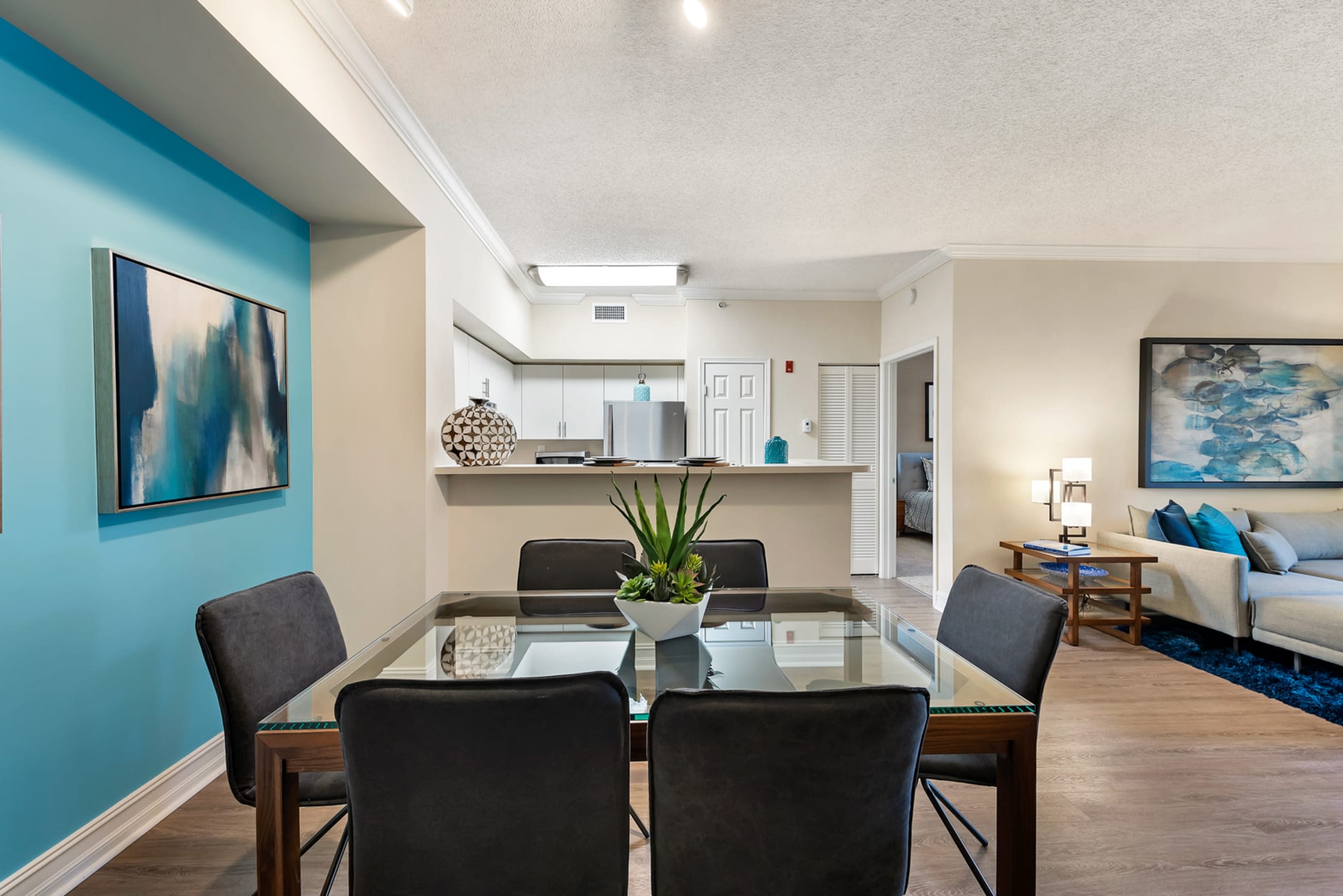 Spacious open concept living room and dining area in a model apartment home at Fountain House Apartments in Miami Lakes, Florida