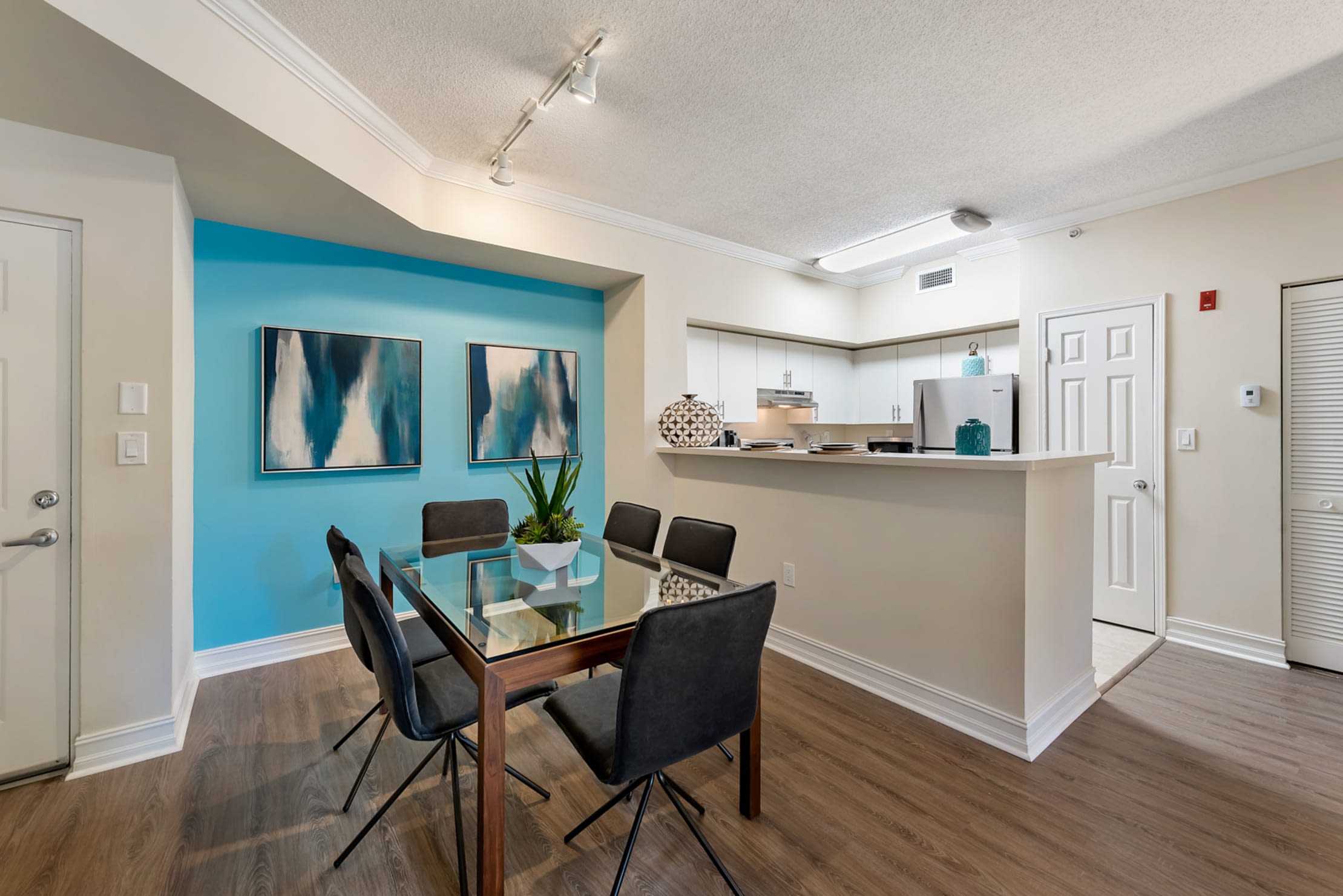 Open concept model dining room and kitchen at Fountain House Apartments in Miami Lakes, Florida