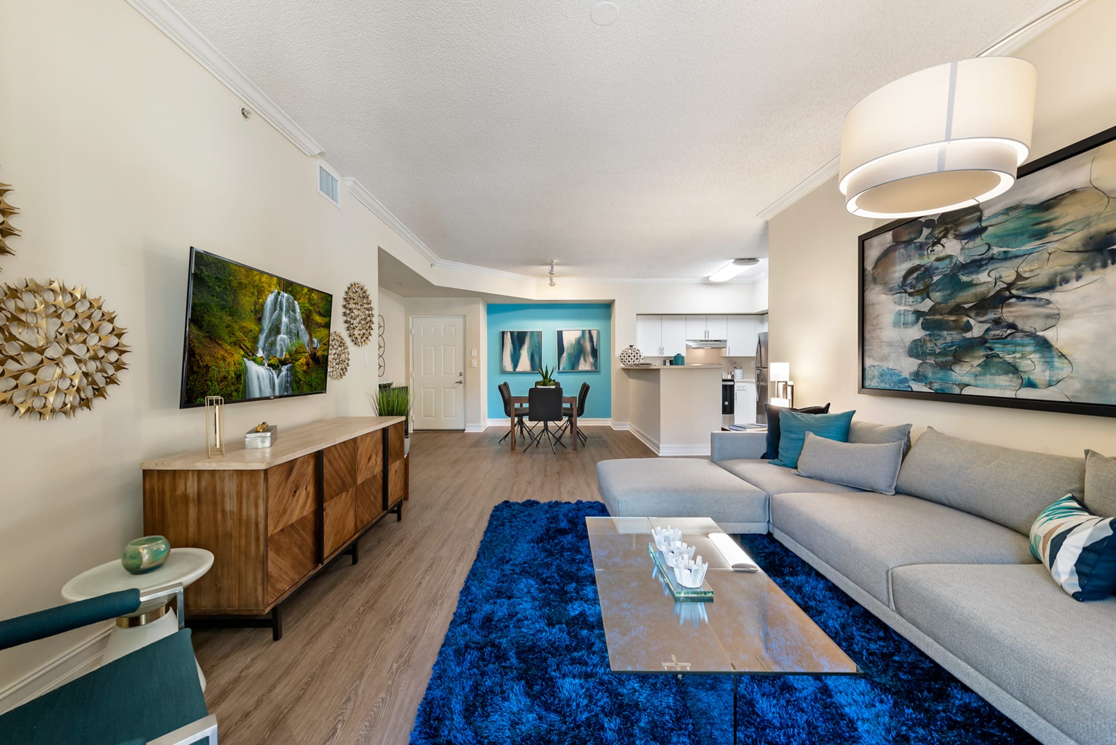 Open concept living room, dining room, and kitchen in a luxury apartment home at Fountain House Apartments in Miami Lakes, Florida