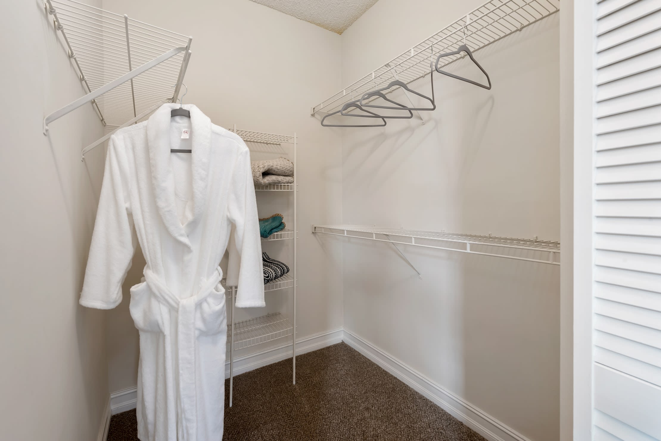 Interior of a large walk-in closet at Fountain House Apartments in Miami Lakes, Florida