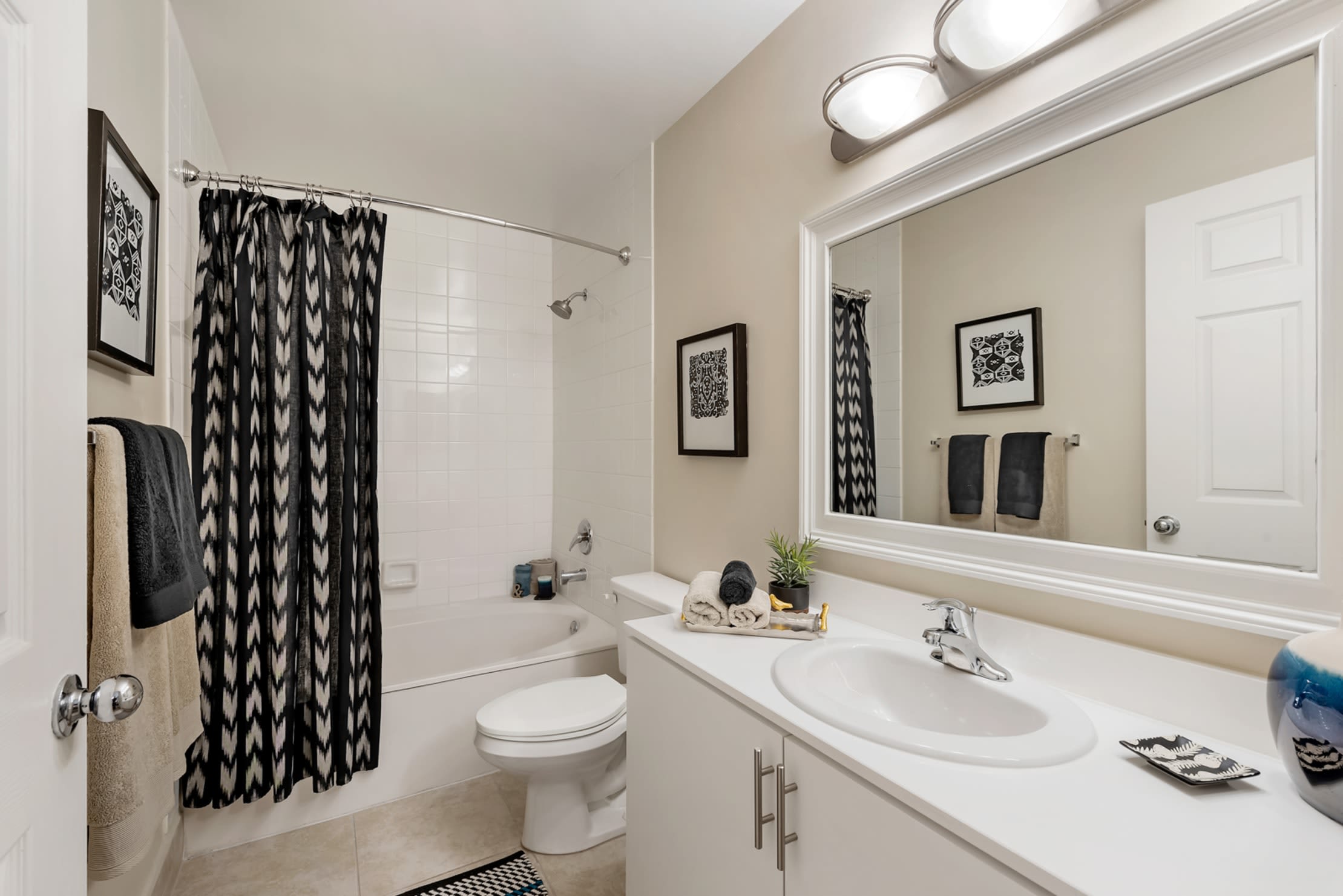 Bathroom with oversized vanity and tiled tub/shower combination at Fountain House Apartments in Miami Lakes, Florida