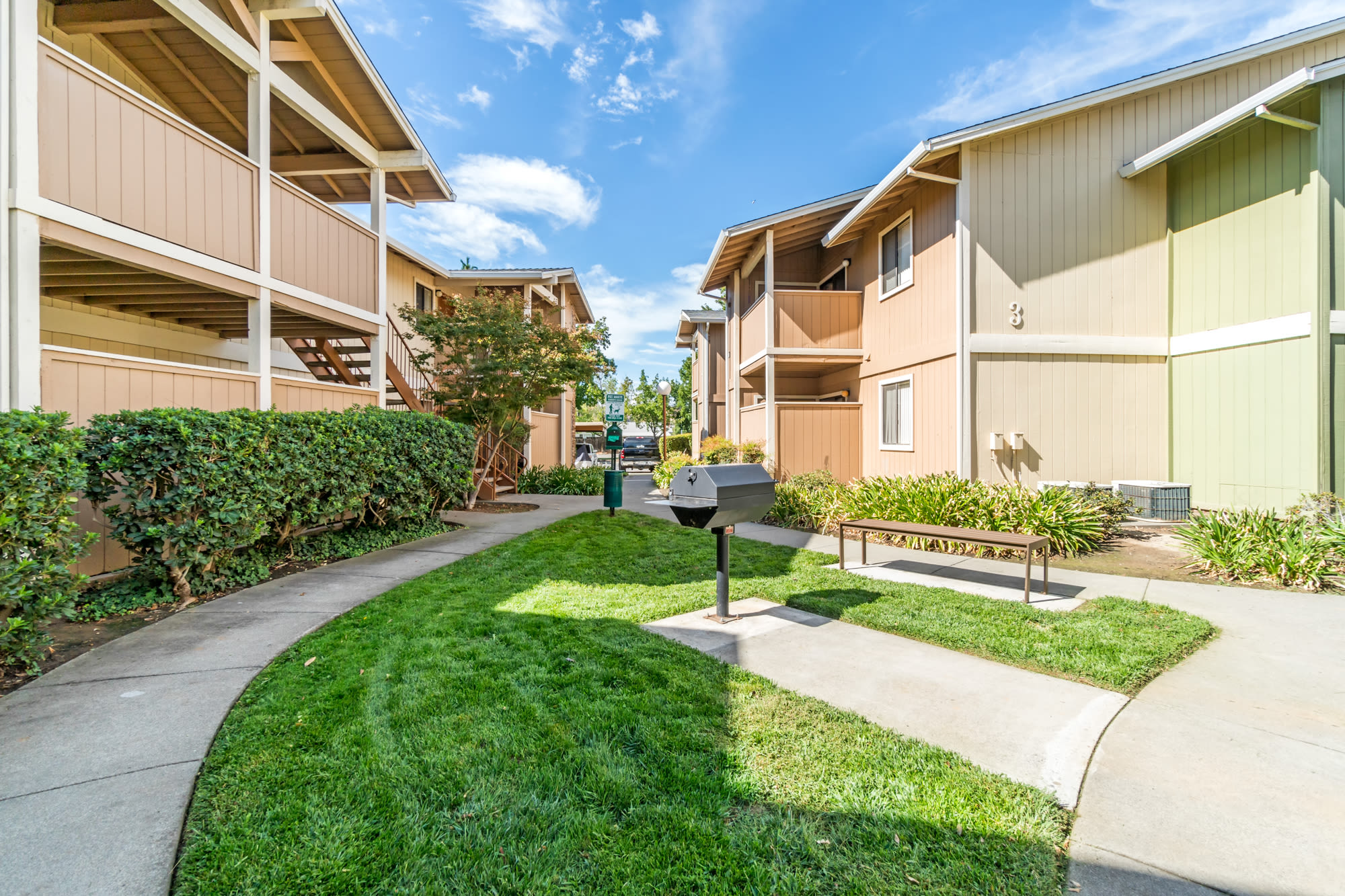 Exterior View of Walkway and BBQ Area at Sommerset Apartments