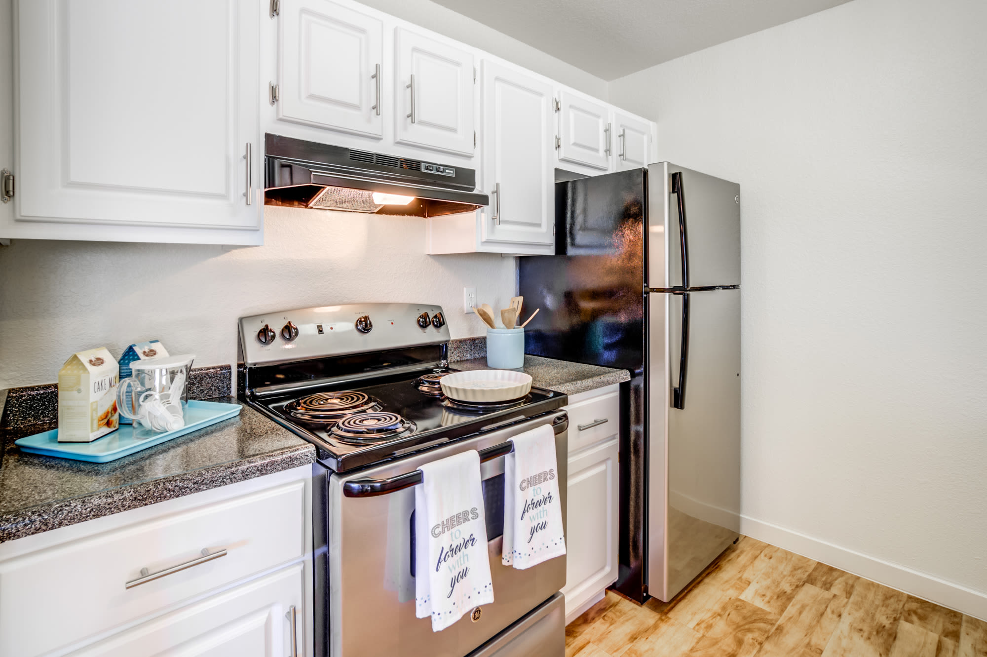 White Cabinetry Kitchen with Stainless steel appliances at Sommerset Apartments in Vacaville