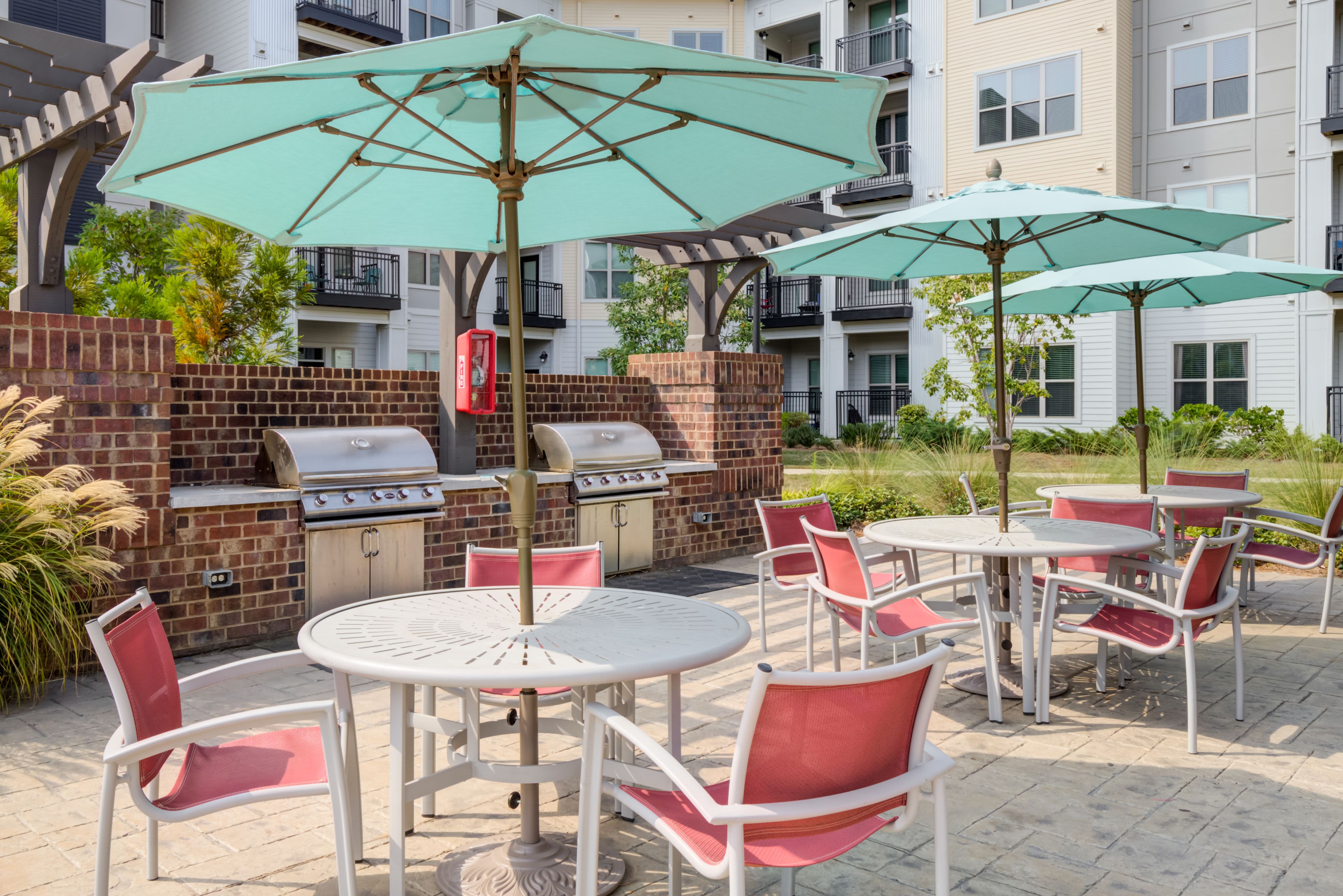 Poolside shaded seating at Celsius Apartment Homes in Charlotte, North Carolina