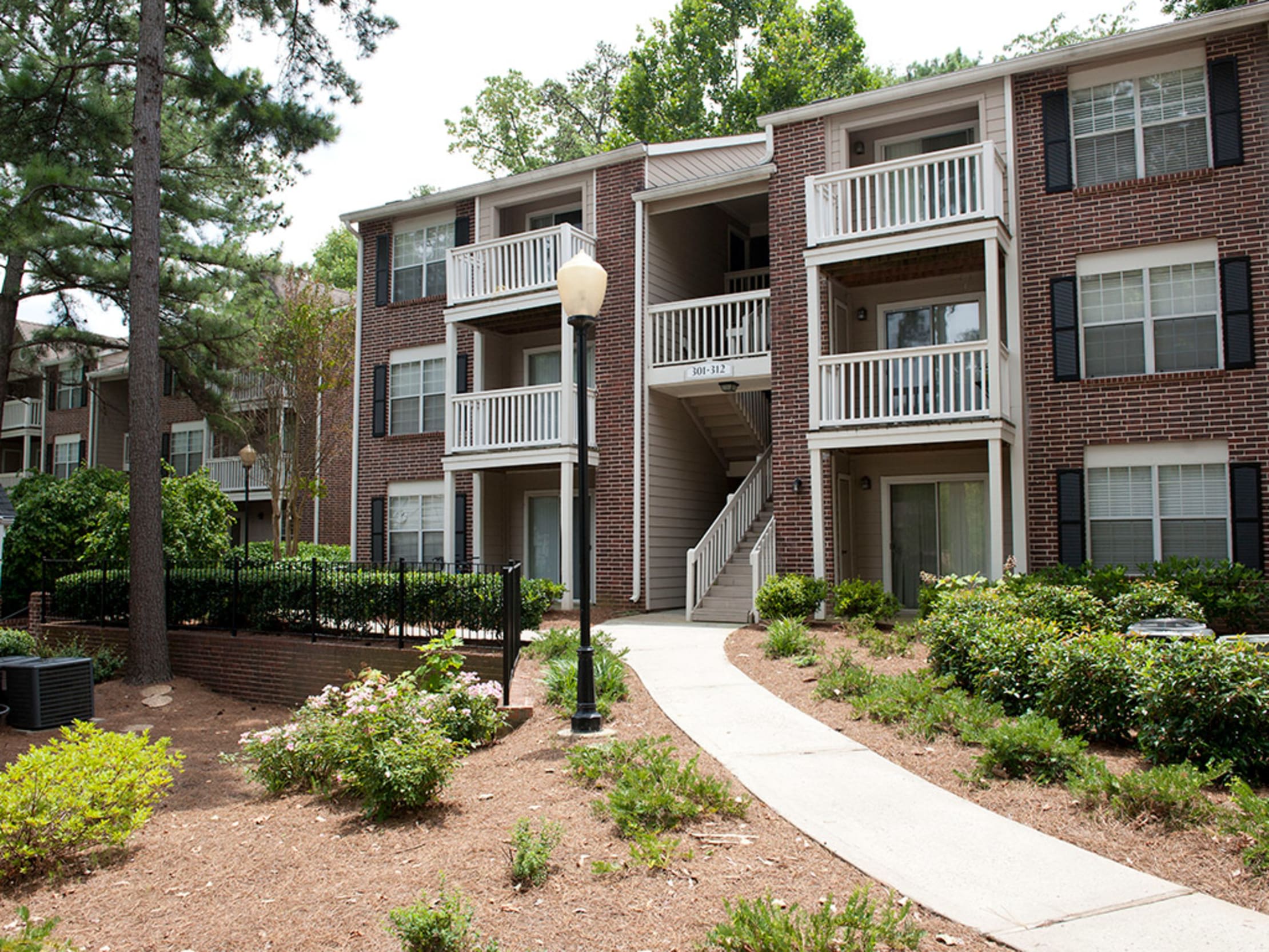 Exterior with a walking path at Castlegate Collier Hills in Atlanta, Georgia