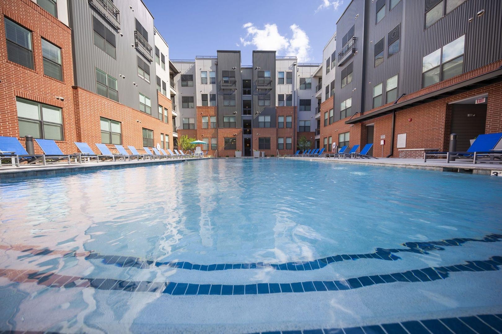 Resort-style pool surrounded by lounge chairs at Steelyard in Oklahoma City, Oklahoma