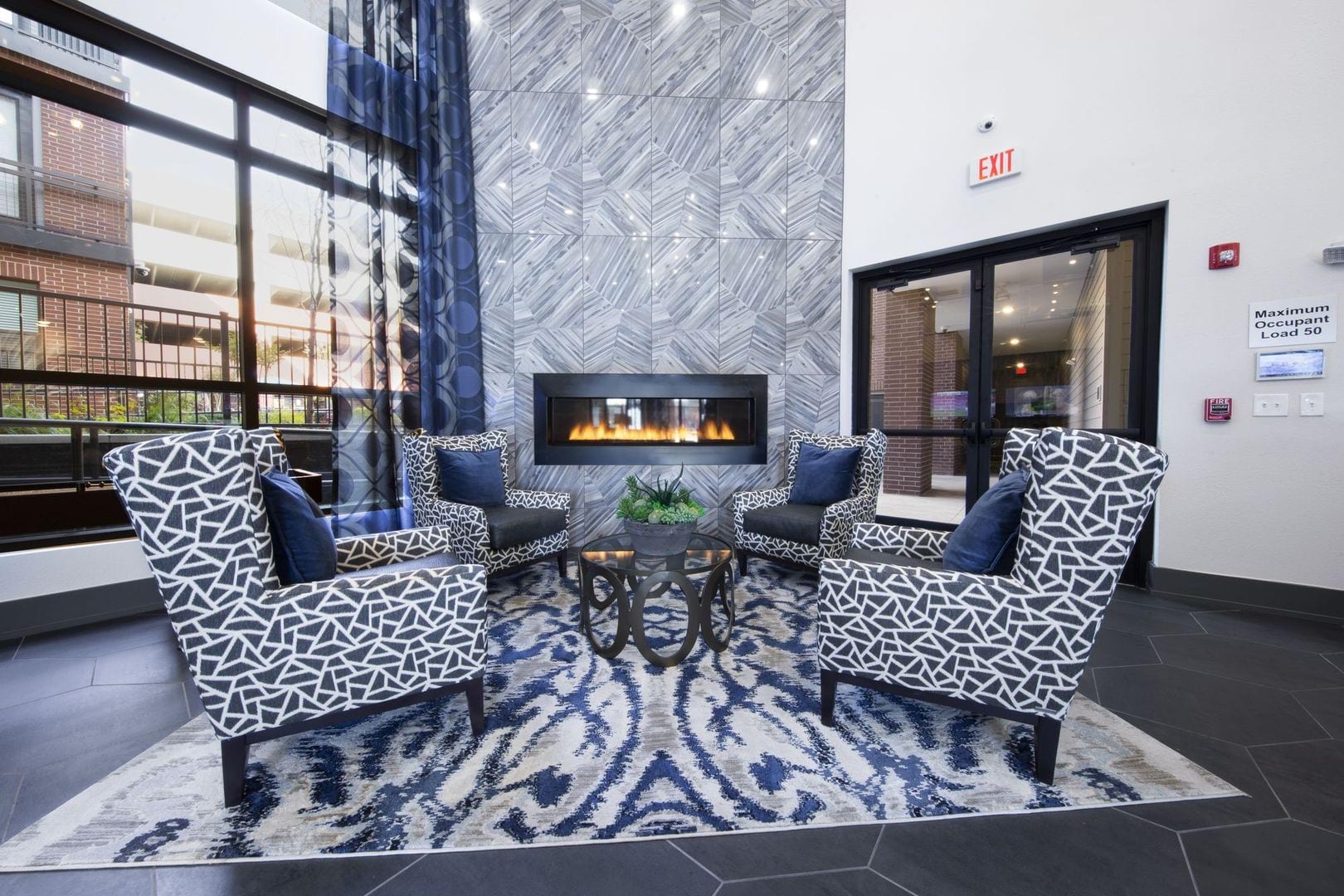 Sitting area in front of the gas fireplace in the stunning resident clubhouse at Steelyard in Oklahoma City, Oklahoma