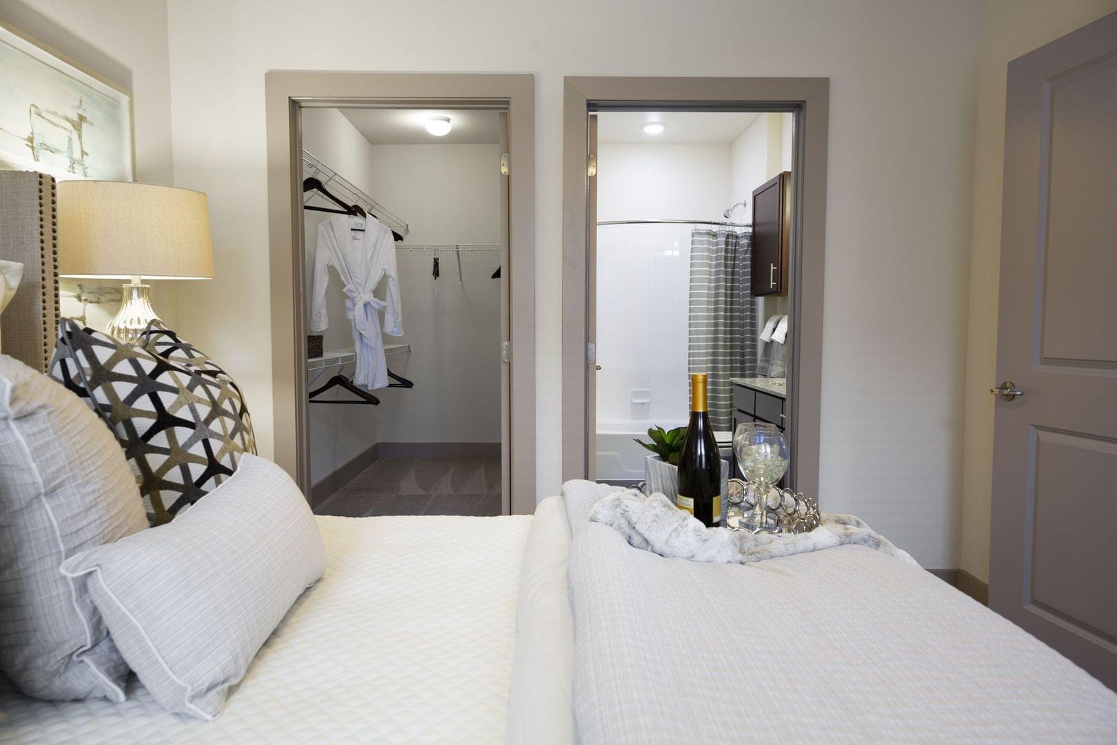 Model bedroom with an expansive walk-in closet and ensuite bathroom at Steelyard in Oklahoma City, Oklahoma