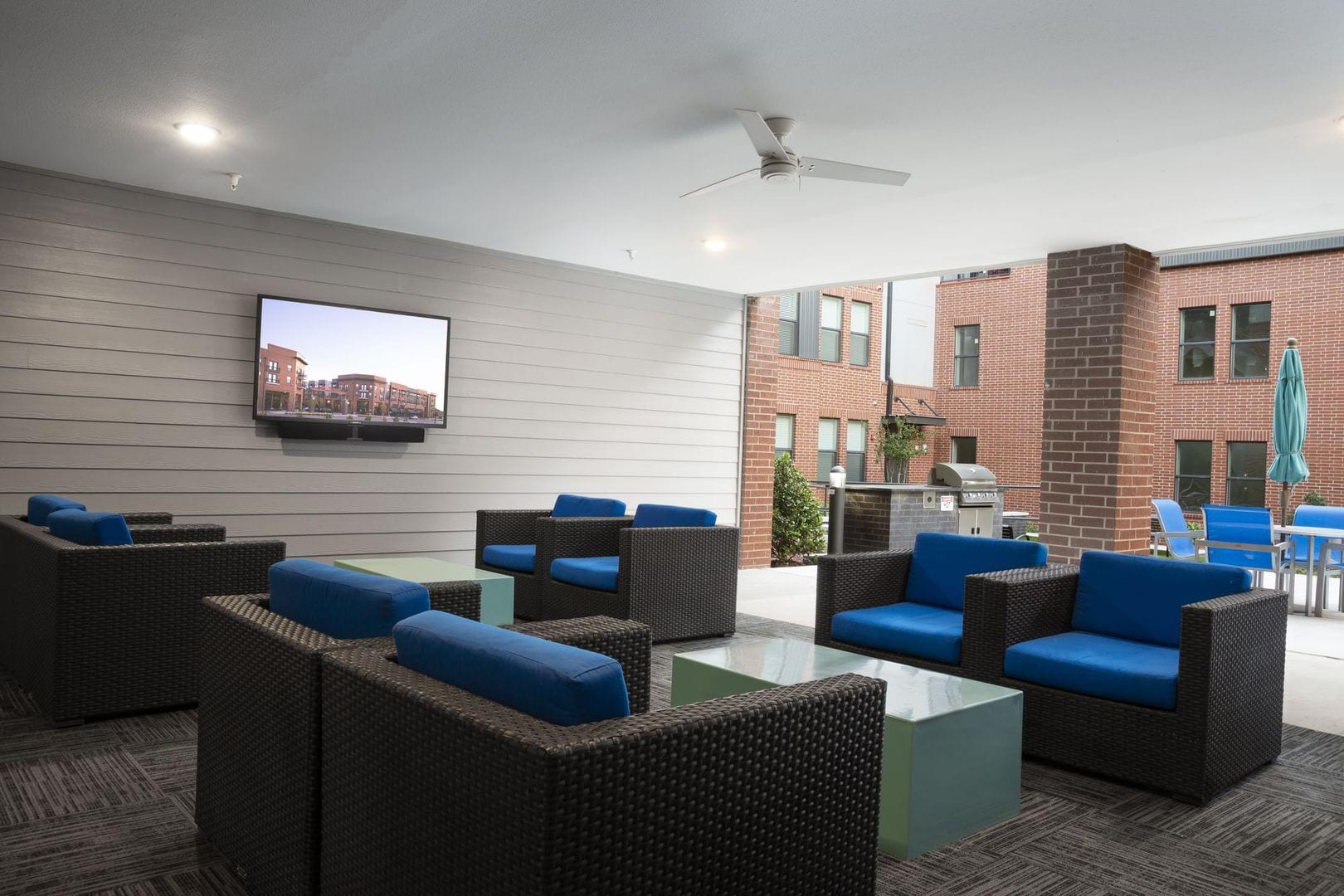 Covered outdoor lounge space with a TV at Steelyard in Oklahoma City, Oklahoma