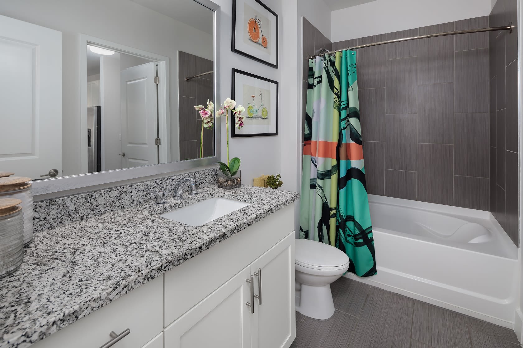 Cute bathroom with a huge mirror and bathtub at Central Station on Orange in Orlando, Florida