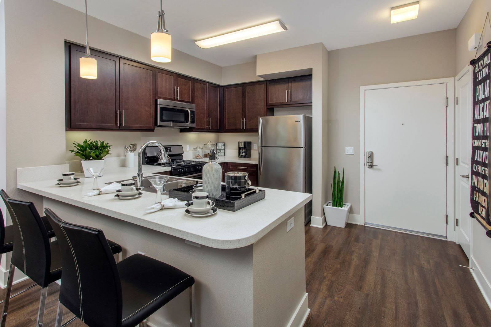 Model kitchen with bar at The Boulevard Apartment Homes in Woodland Hills, California