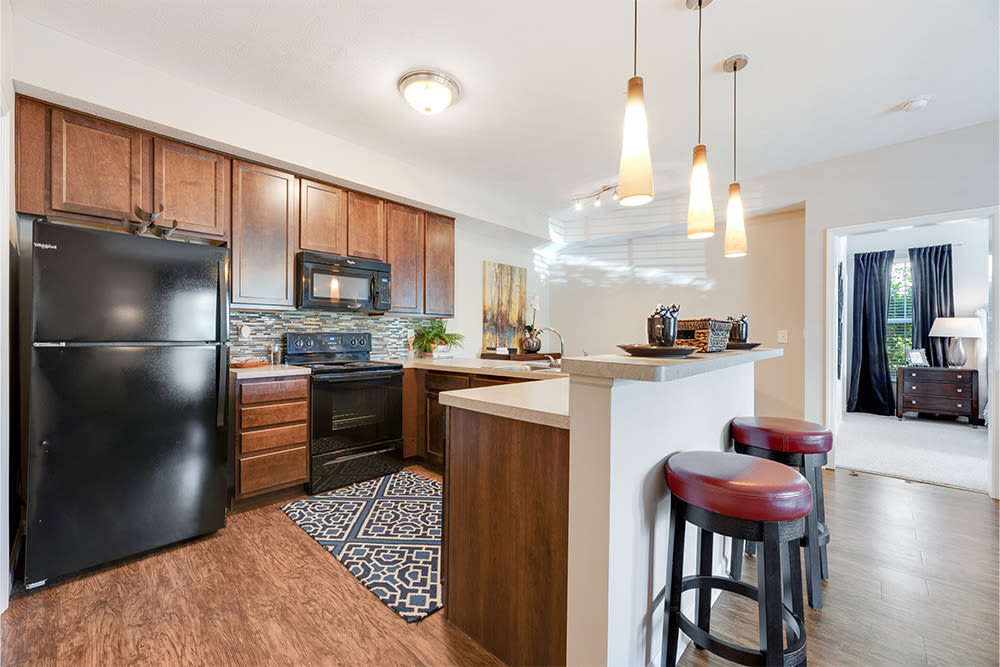Beautiful kitchen with black appliances at Clifton Park Apartment Homes in New Albany, Ohio