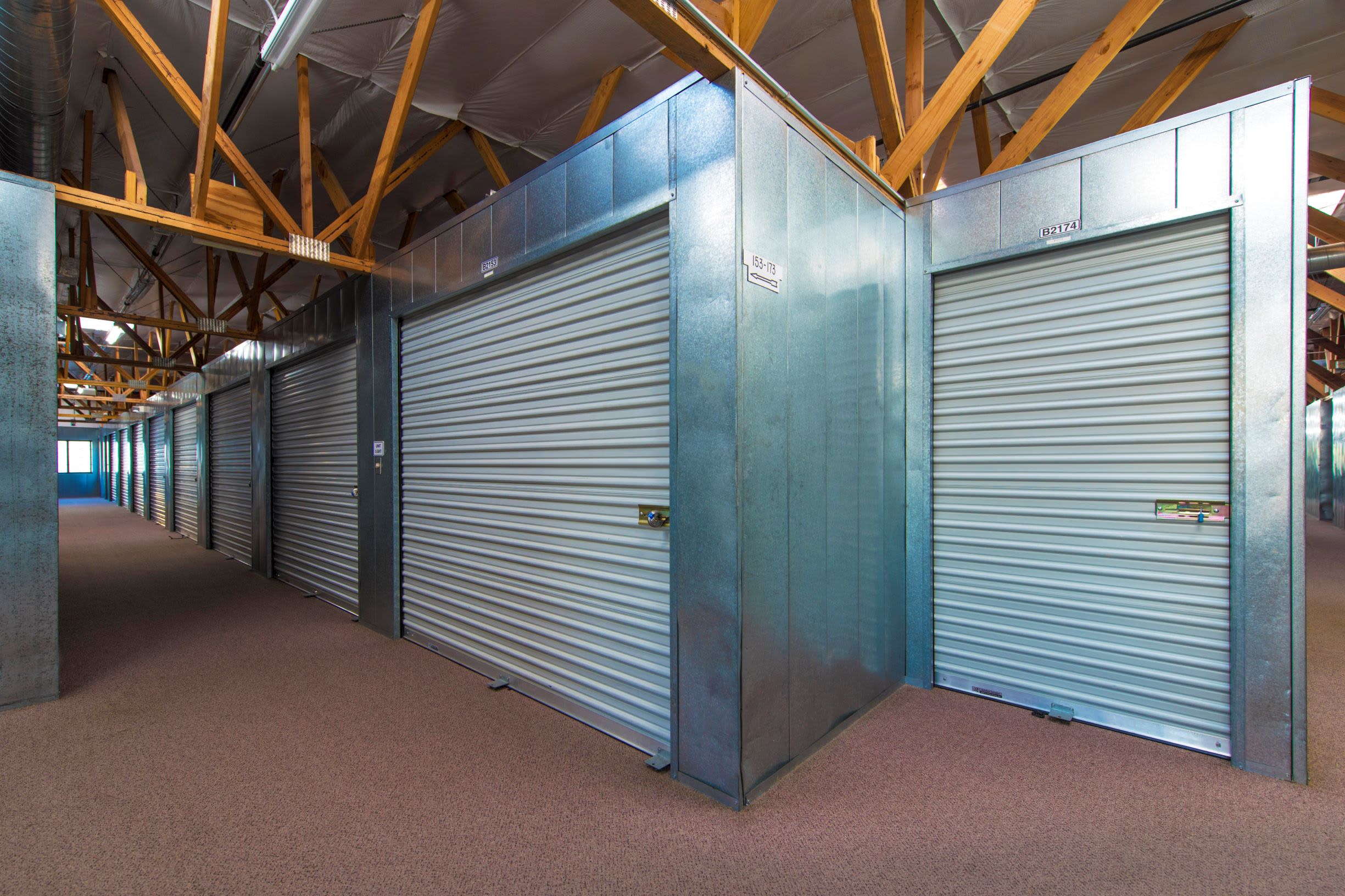 A row of storage units in a hallway at Poway Road Mini Storage in Poway, CA
