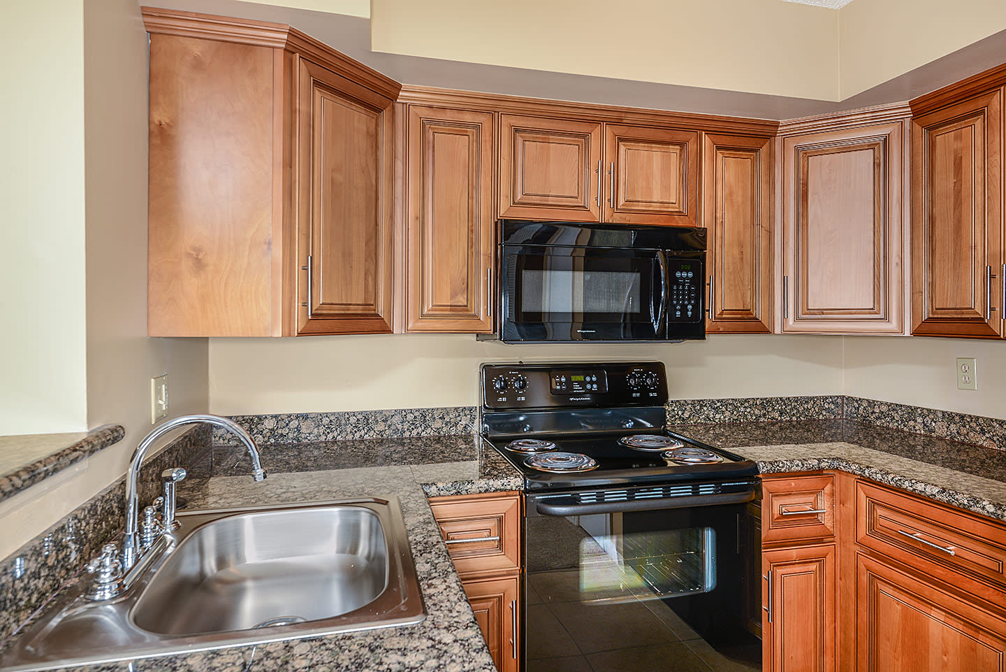 Model kitchen with updated appliances at Royal St. George at the Villages Apartment Homes in West Palm Beach, Florida