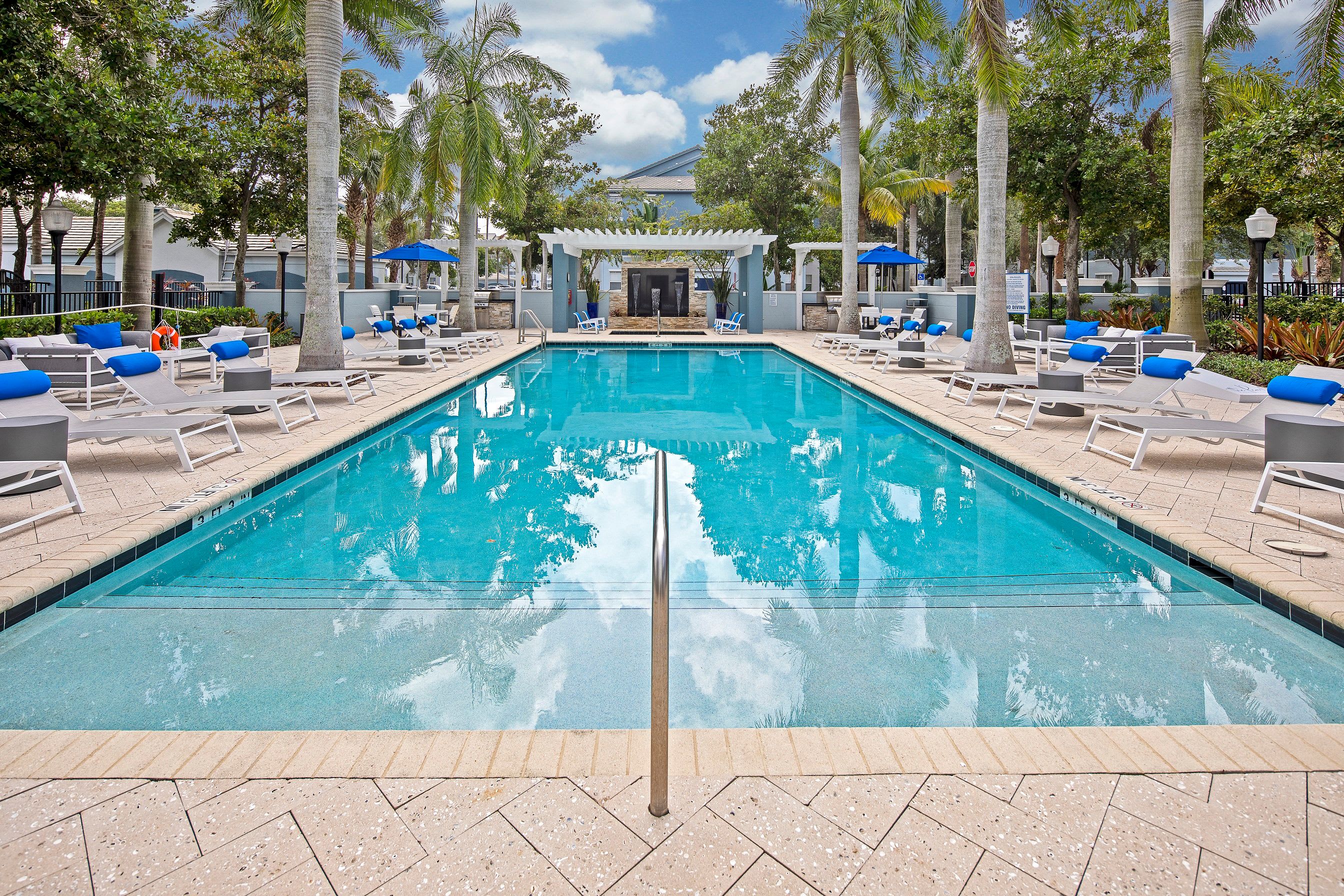  Resort style swimming pool surrounded by palm trees at The Pearl in Ft Lauderdale, Florida