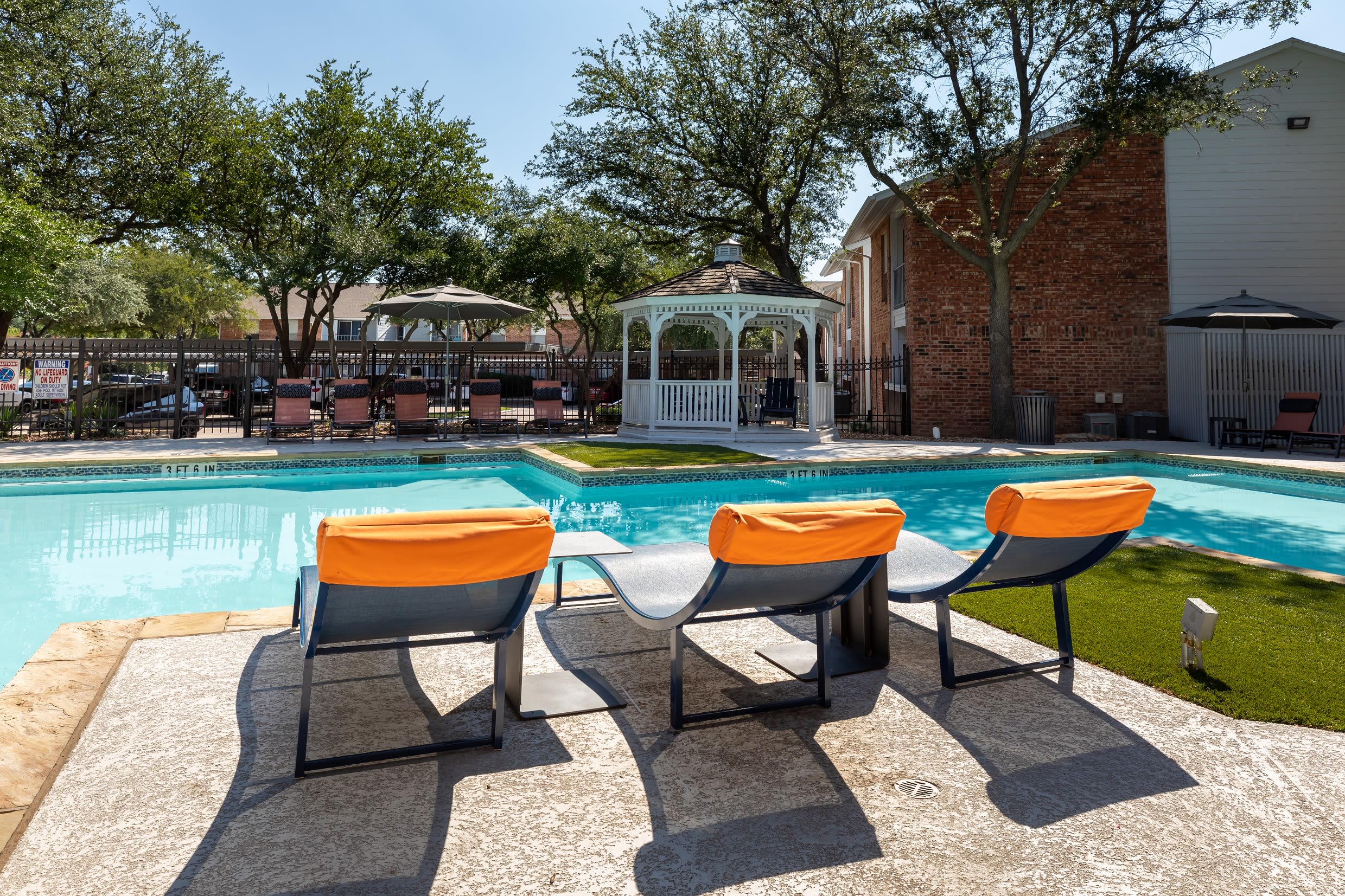 A pool with lounge furniture at Canopy on Central in Bedford, Texas