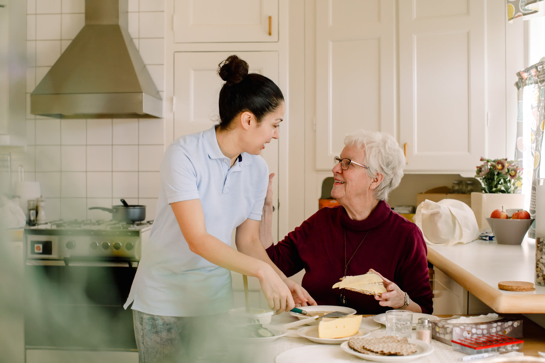 Resident receiving meal assistance in her home at Fair Oaks Health Care Center in Crystal Lake, Illinois