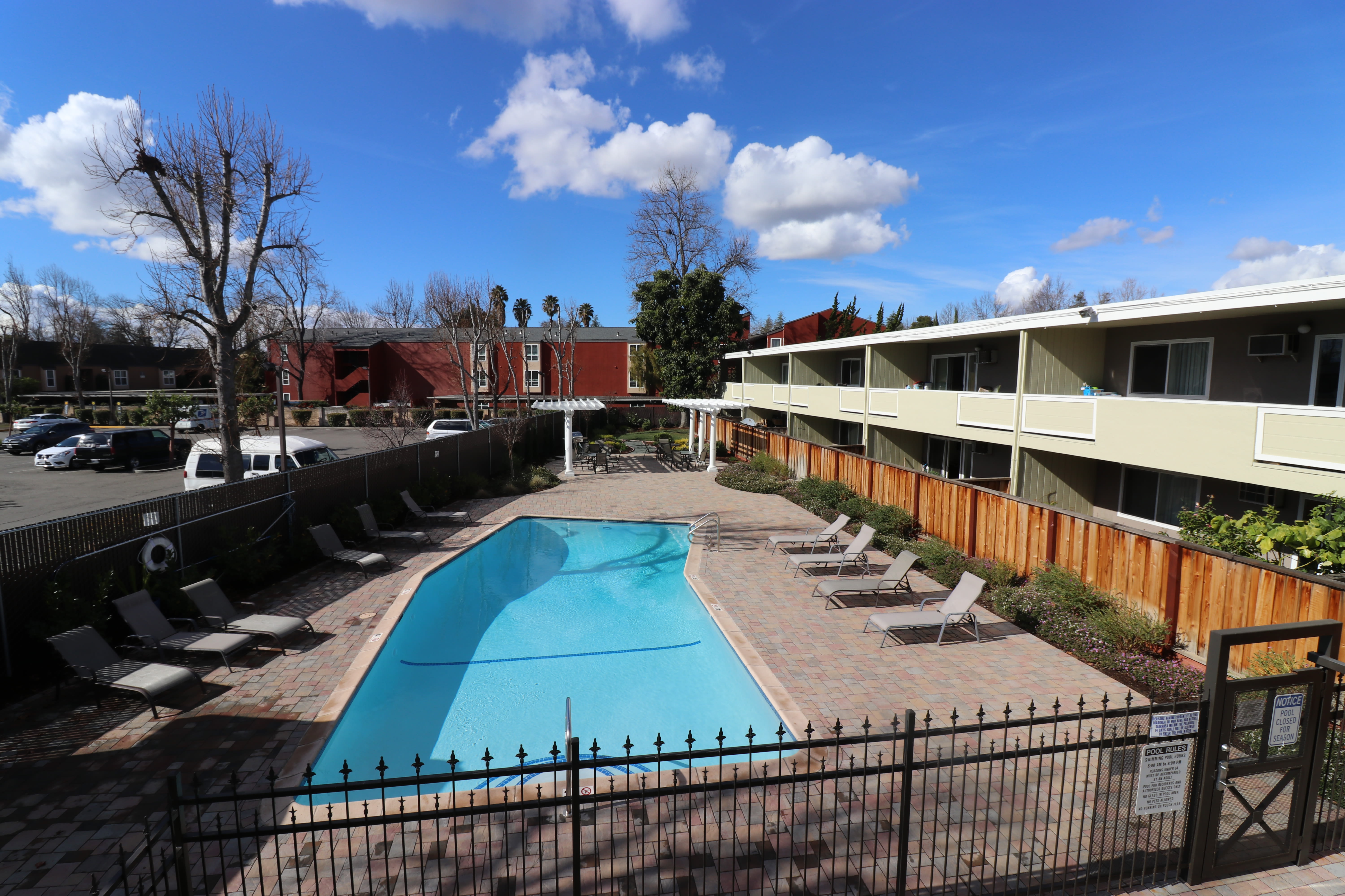 Chaise lounge chairs by the pool at Parkway Apartment Homes in Fremont, California