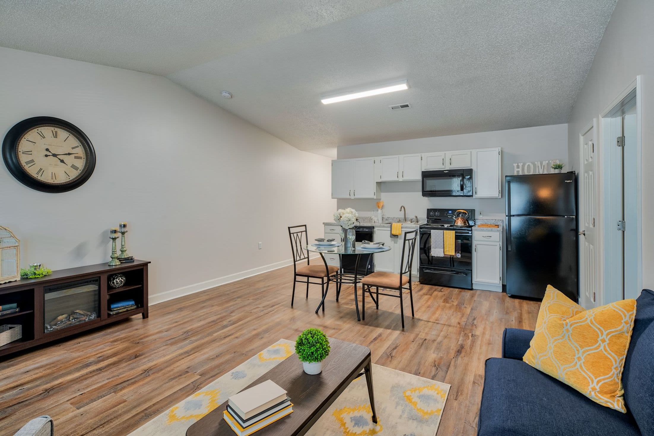 Spacious apartment with wood-style flooring at Leisure Living in Evansville, Indiana