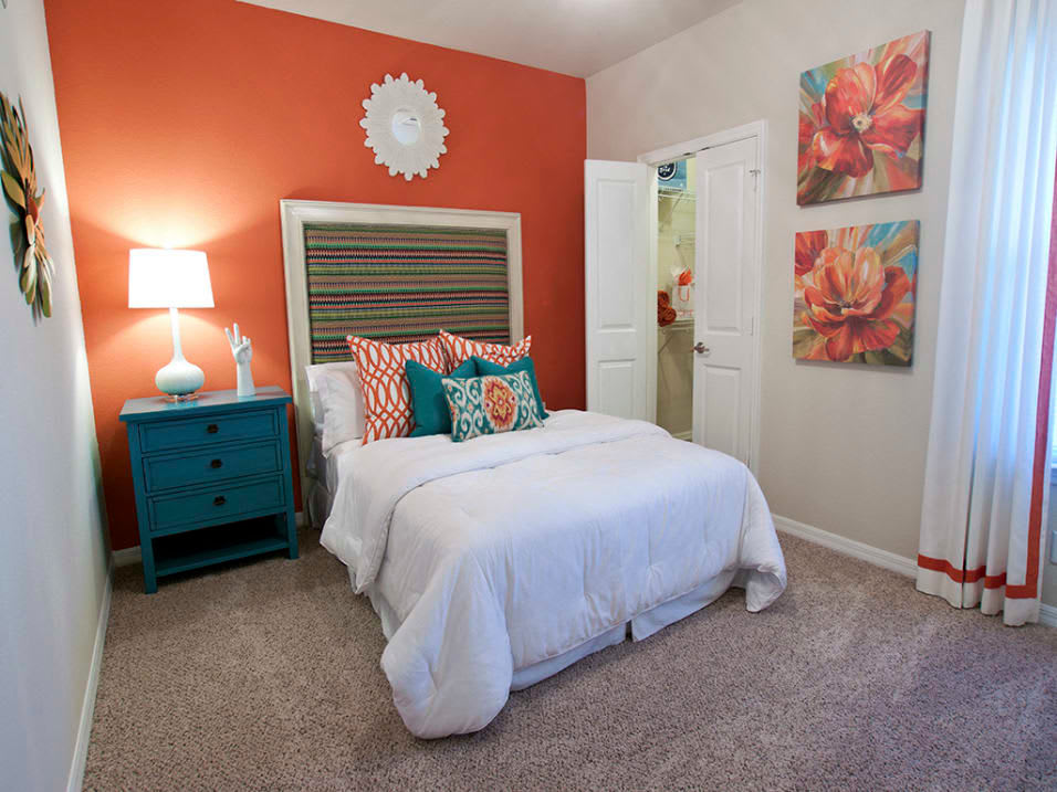 Well-furnished bedroom at Latitude at Mallard Creek in Charlotte, North Carolina