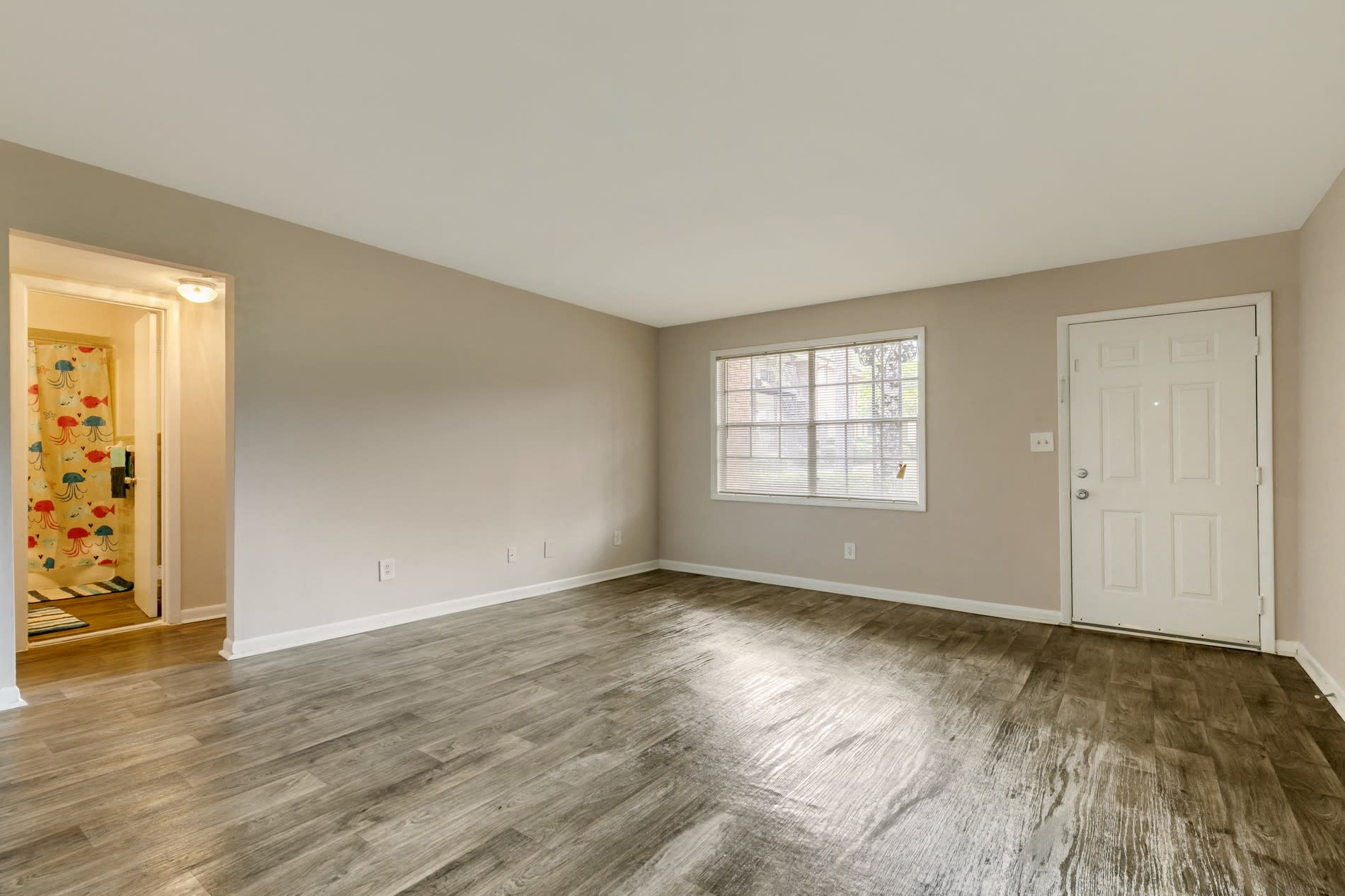 Spacious living room with plank flooring at ibex Park in Smyrna, Georgia