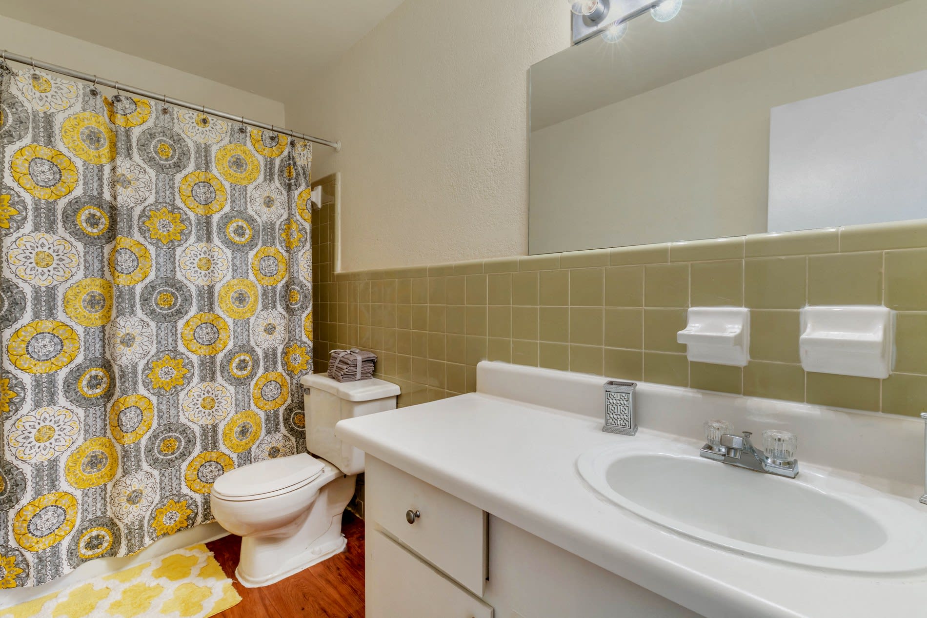 Model bathroom with colorful shower curtain at Galleria Courtyards in Smyrna, Georgia