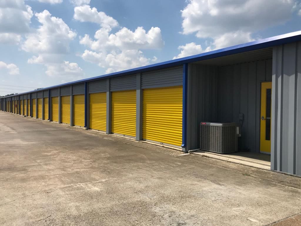 Outdoor drive-up units with brown doors at Storage Star Tomball in Tomball, Texas