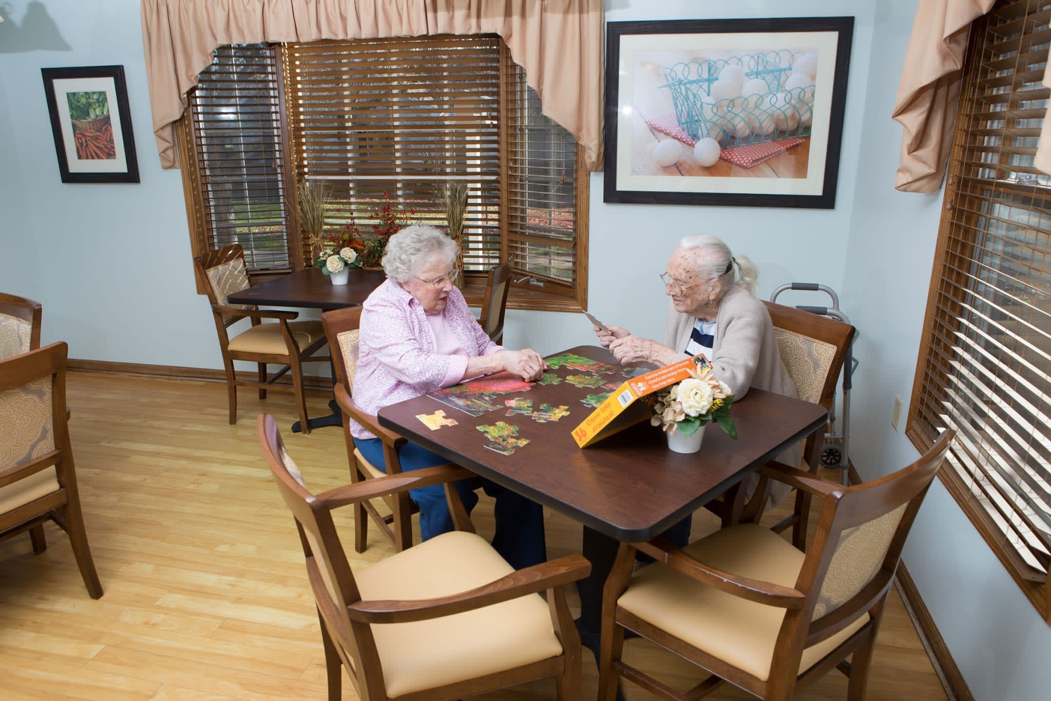 Two residents doing a puzzle at Country Manor Memory Care in Davenport, Iowa. 