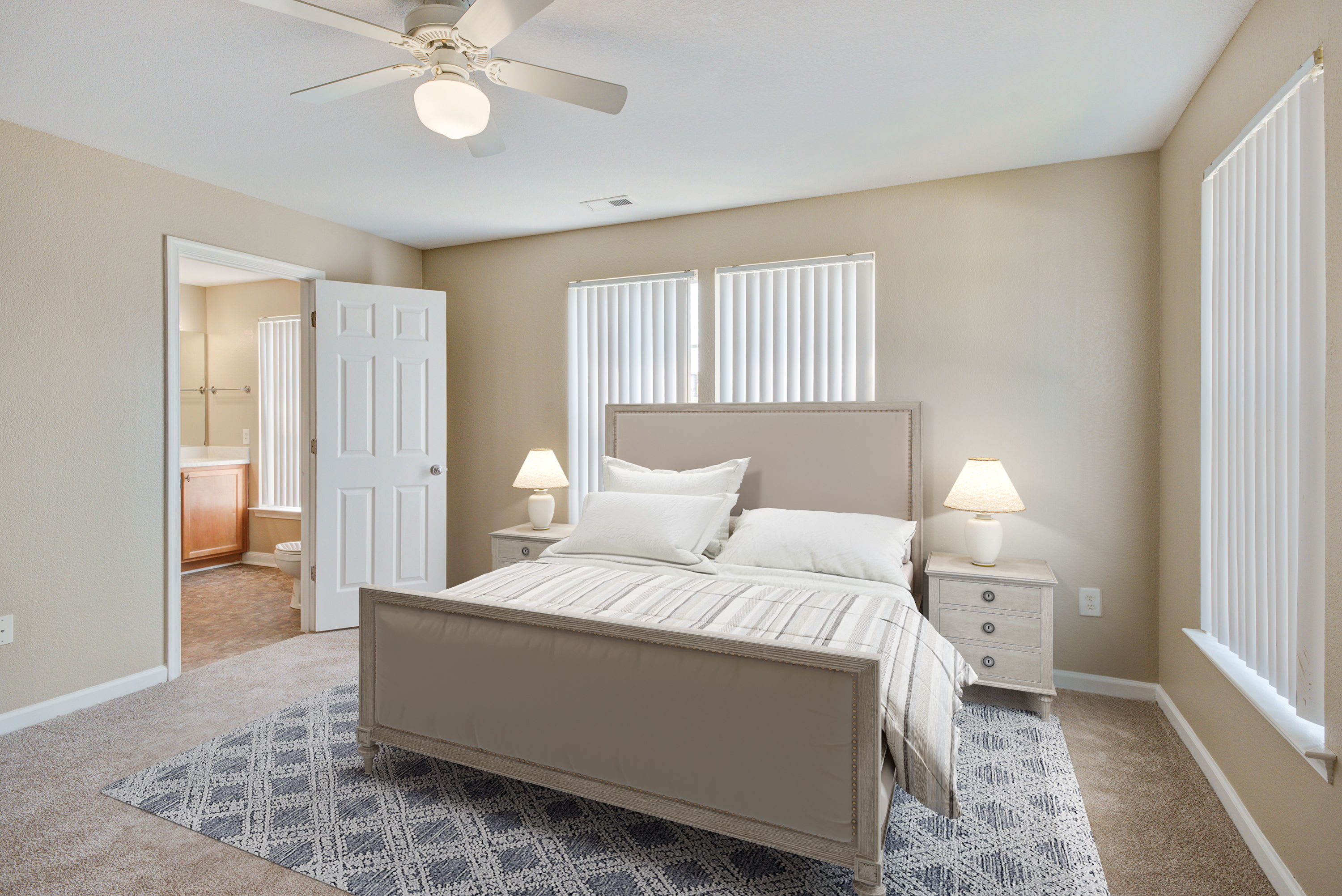 A furnished main bedroom in a home at The Village at Whitehurst Farm in Norfolk, Virginia