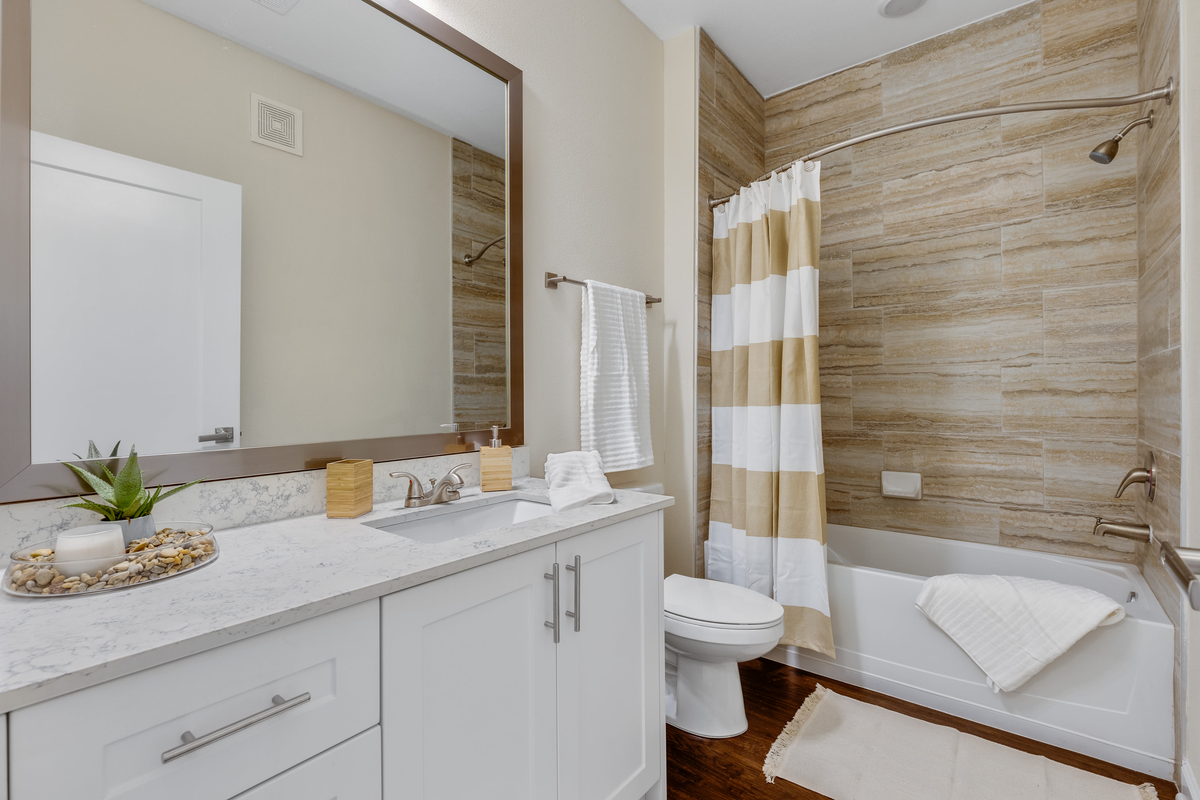 Bathroom with oversized vanity, soaking tub and tiled shower at The Point at Town Center in Jacksonville, Florida