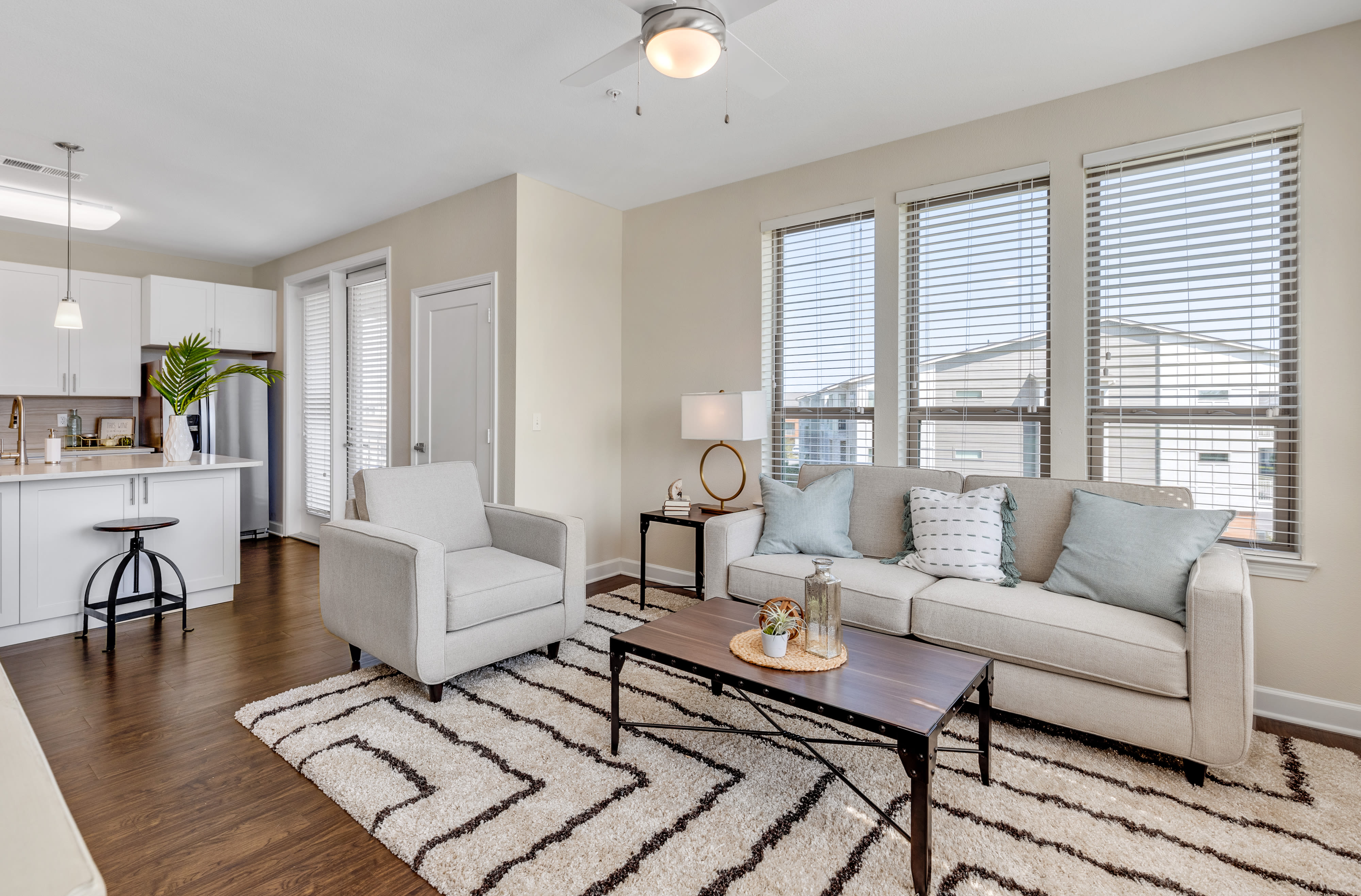 Living room and kitchen in a model apartment home at The Point at Town Center in Jacksonville, Florida