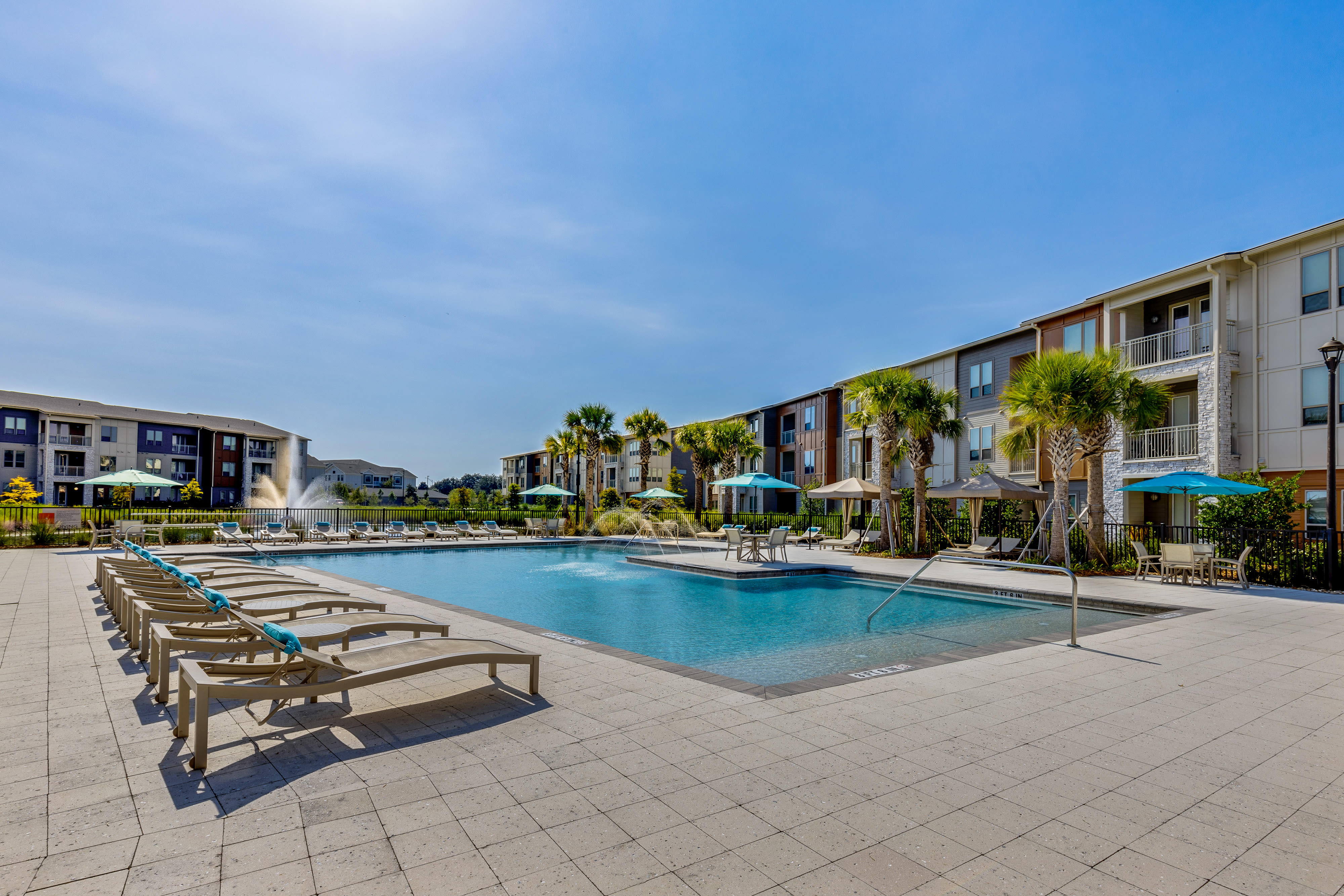 Resort-style swimming pool and poolside cabanas at The Point at Town Center in Jacksonville, Florida