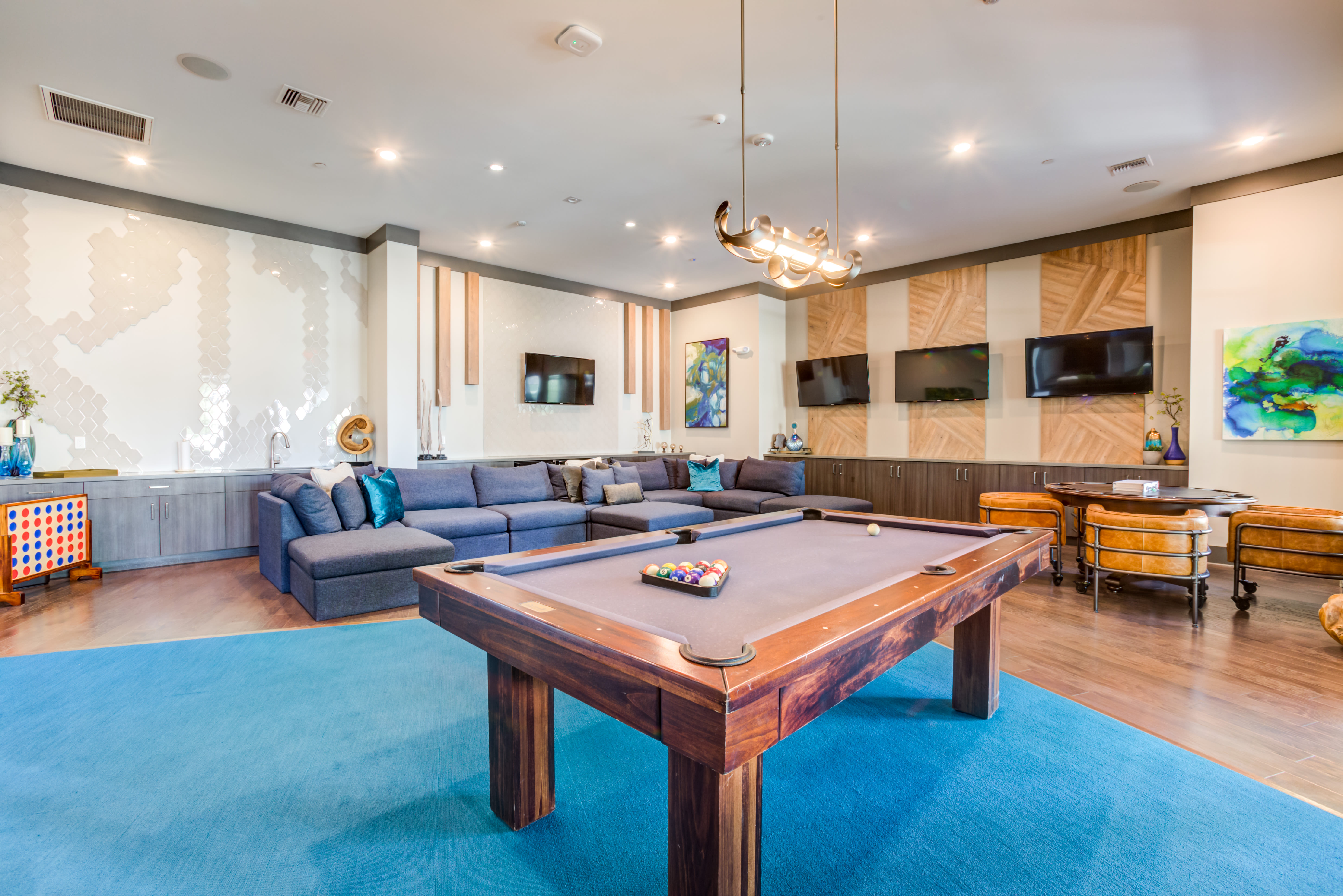 Game room with pool table and large flat screen TVs at Town Commons in Gilbert, Arizona