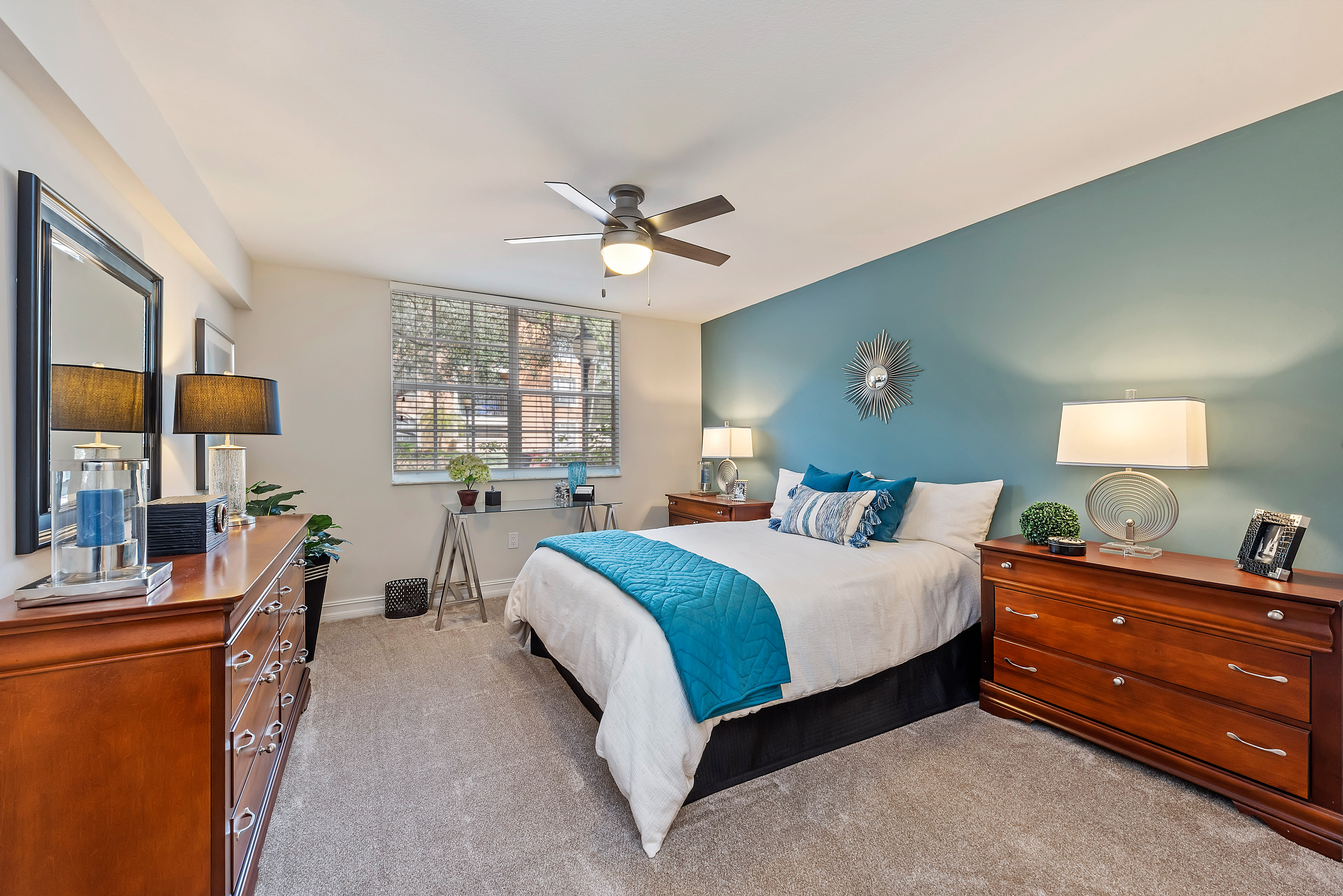 Fully furnished model bedroom with ceiling fan at Crescent House Apartments in Miami Lakes, Florida