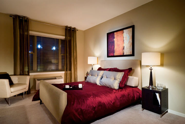 Model bedroom decorated with cozy lighting at 55 Riverwalk Place in West New York, New Jersey