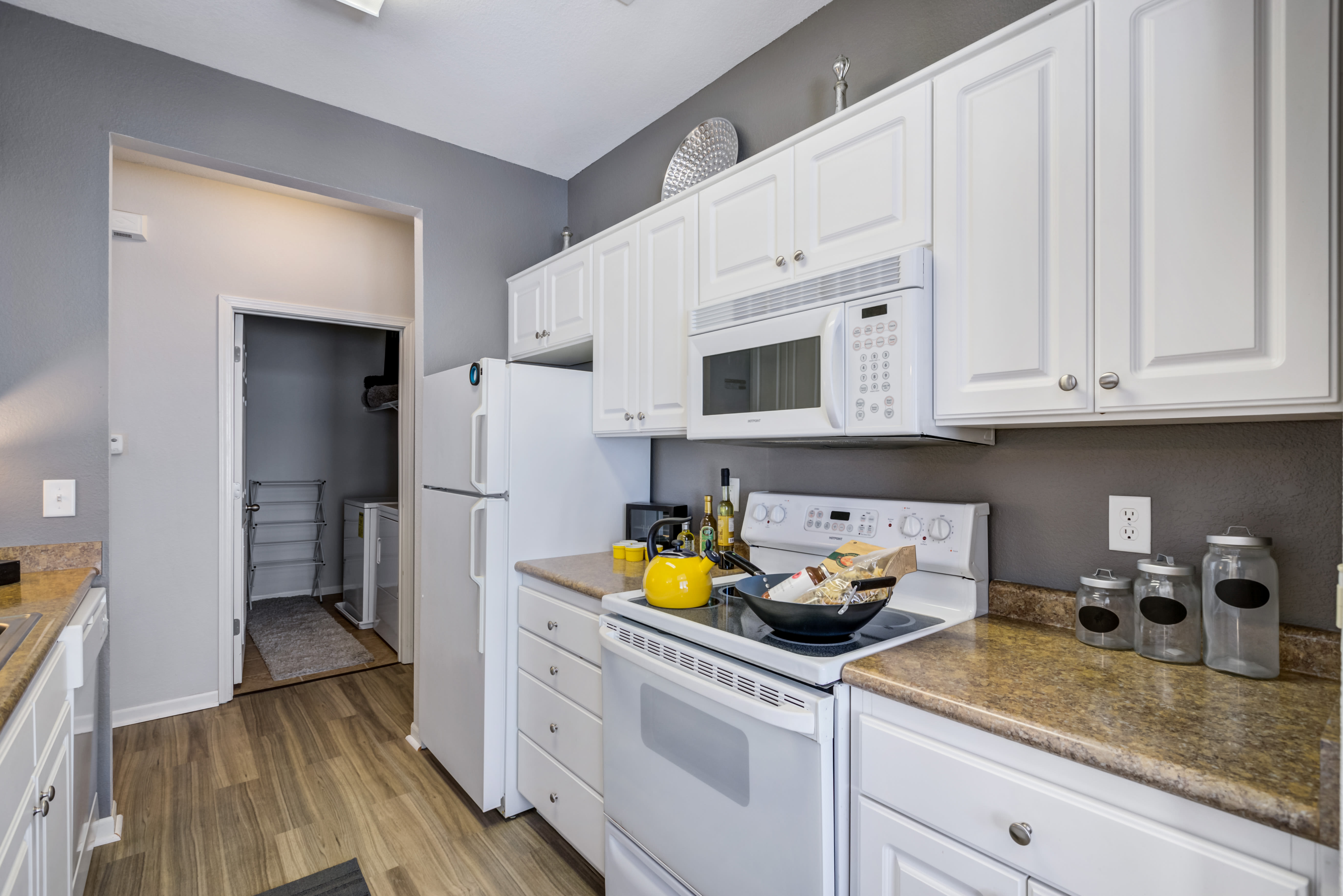 Kitchen with white cabinets and stainless-steel sink at Alvadora Apartments in Lawrence, Kansas