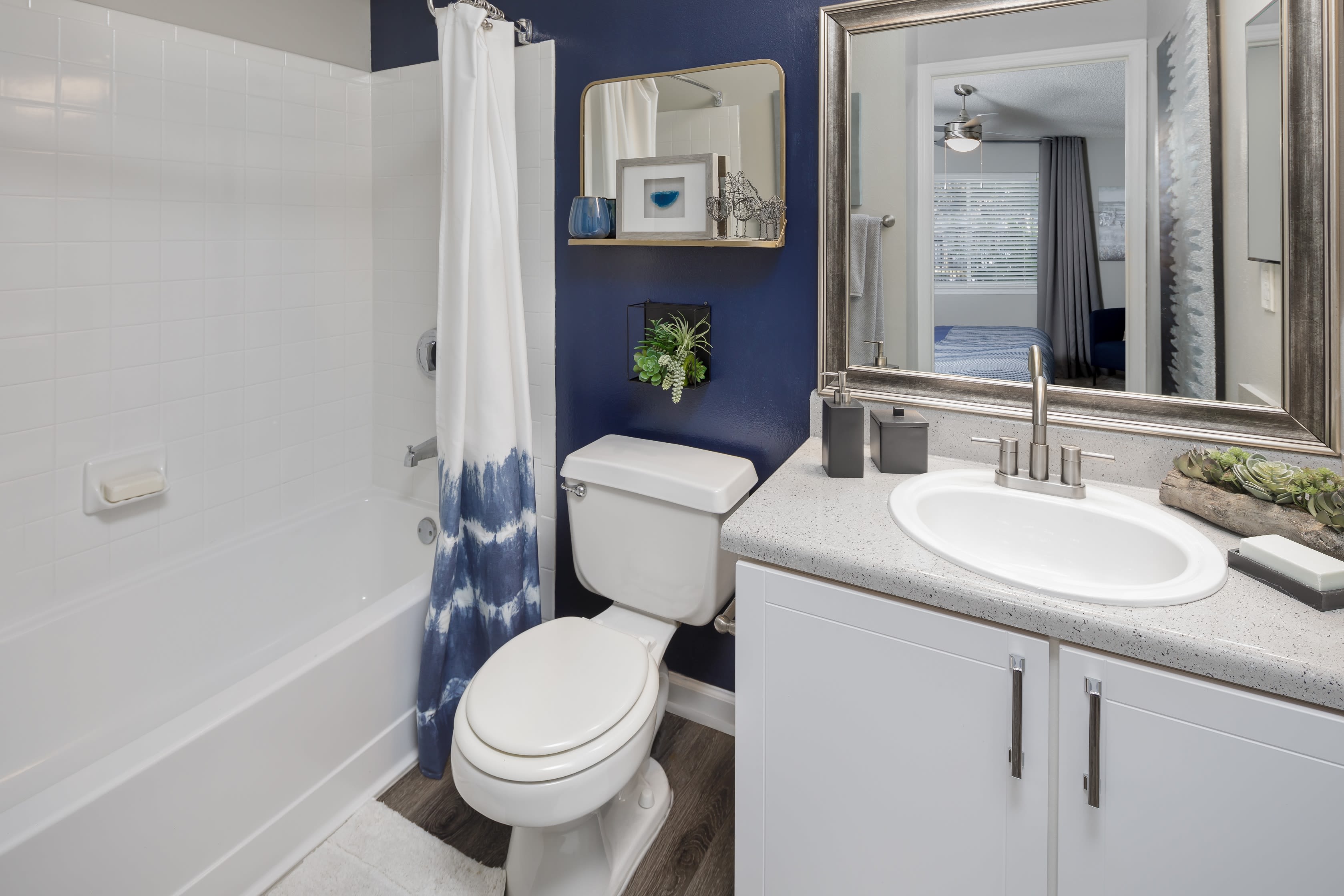 A well decorated bathroom in an apartment at 1801 MetroWest in Orlando, Florida