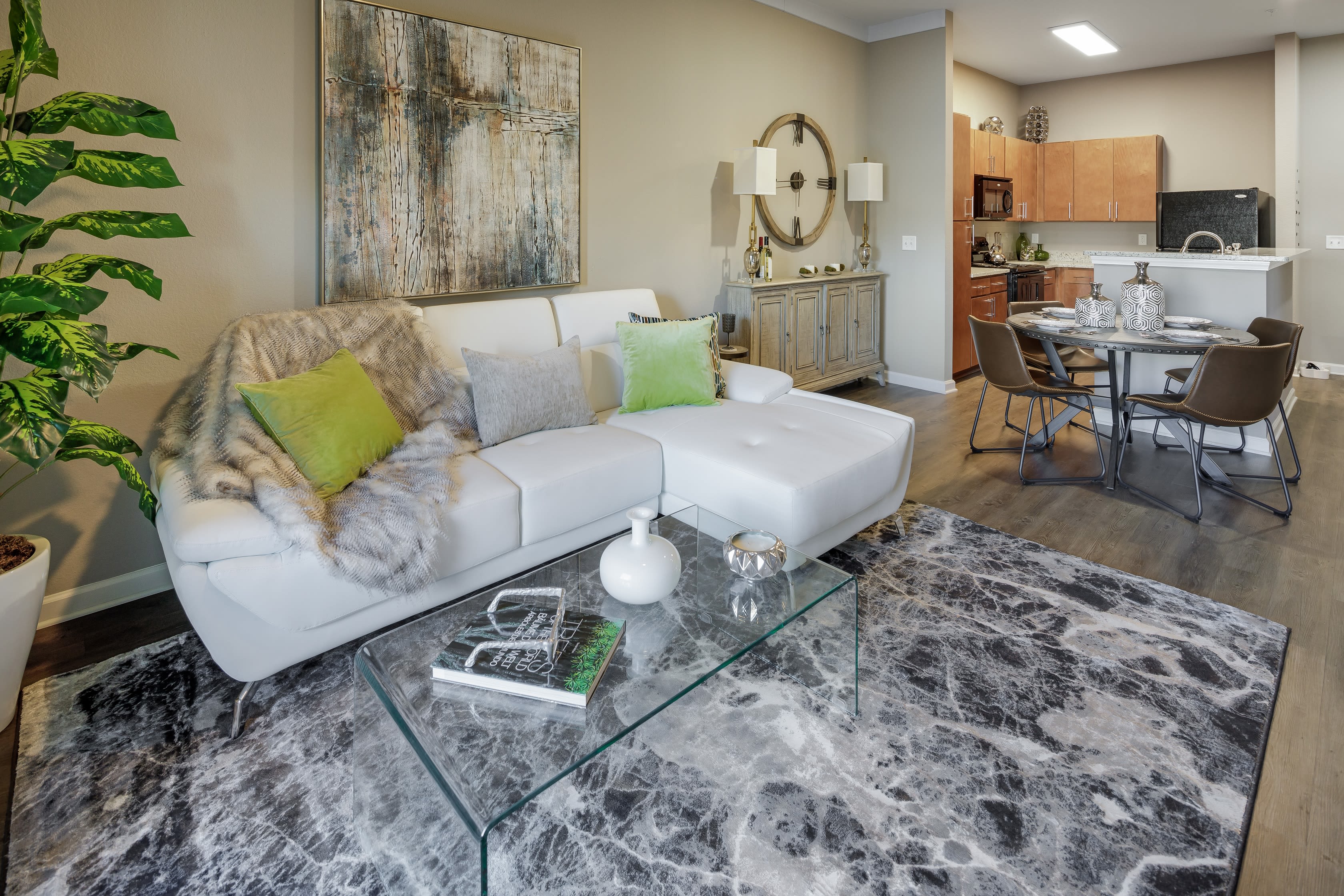 Model living room with door to balcony at Celsius Apartment Homes in Charlotte, North Carolina