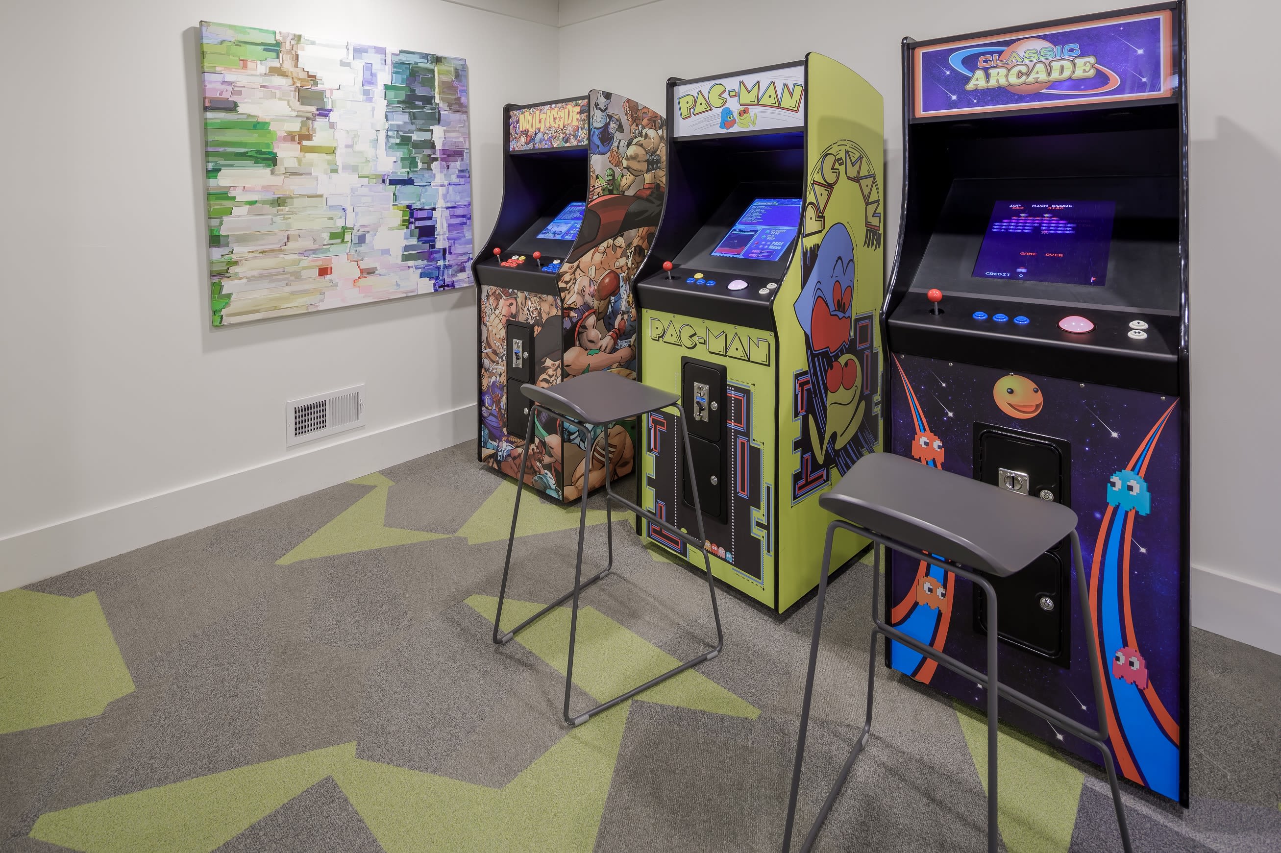 Game room with arcade games at Celsius Apartment Homes in Charlotte, North Carolina