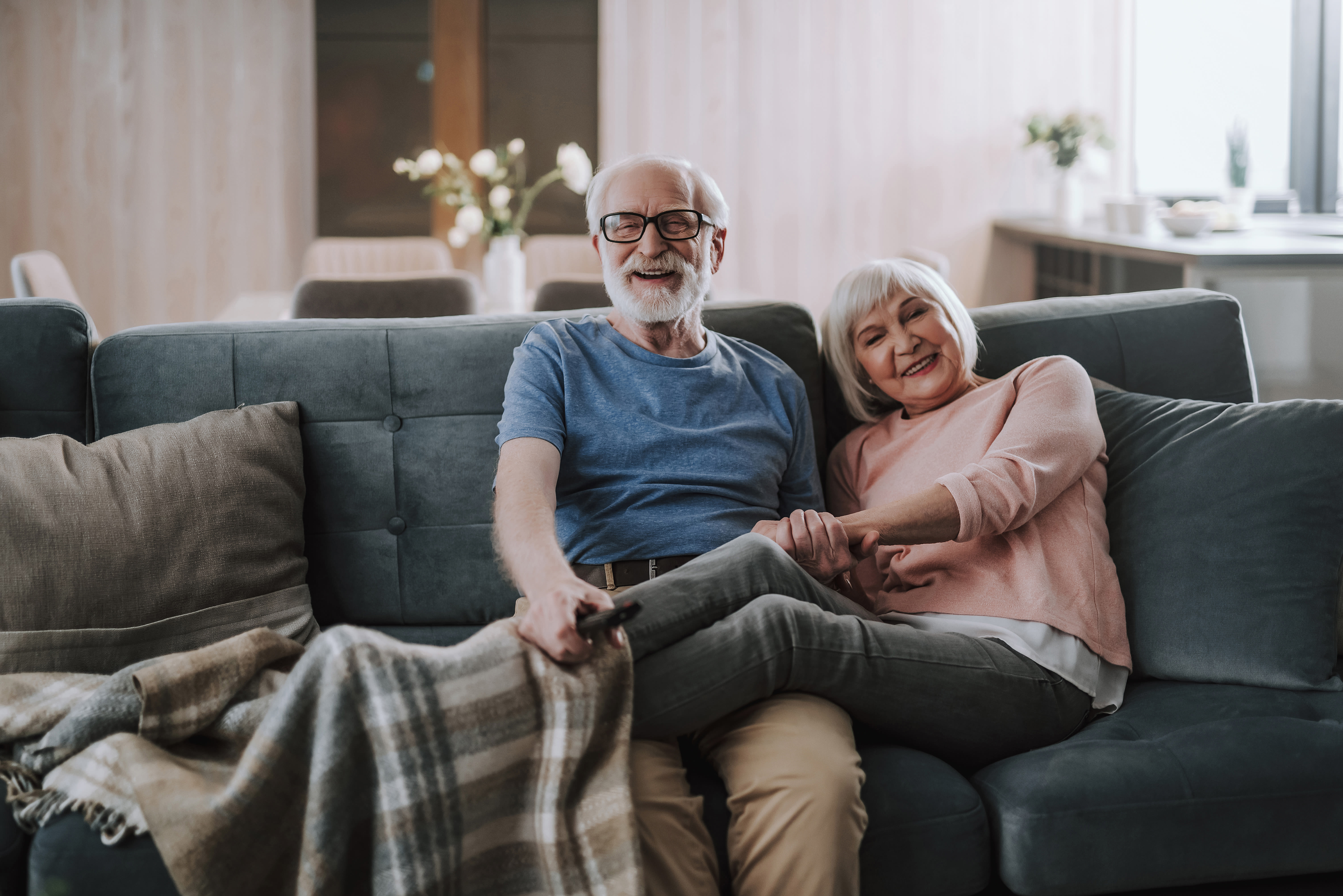 Residents enjoying a comfy morning on the sofa at Truewood by Merrill, West Covina in West Covina, California. 