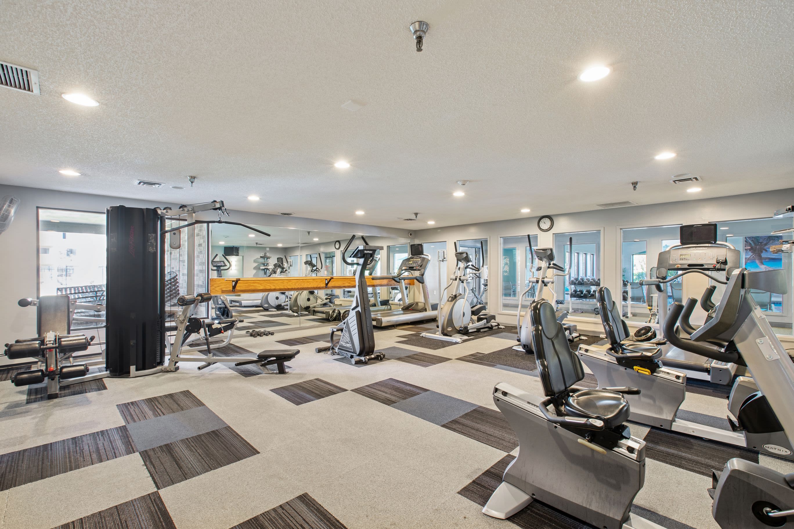 A modern fitness center with plenty of equipment at Pointe West Apartment Homes in West Des Moines, Iowa