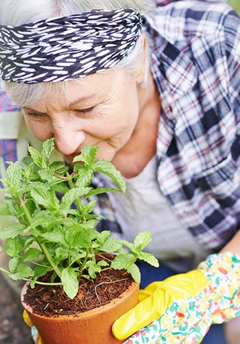 One of our happy residents tending to her flowers at Glenwood in Dublin, Ohio.