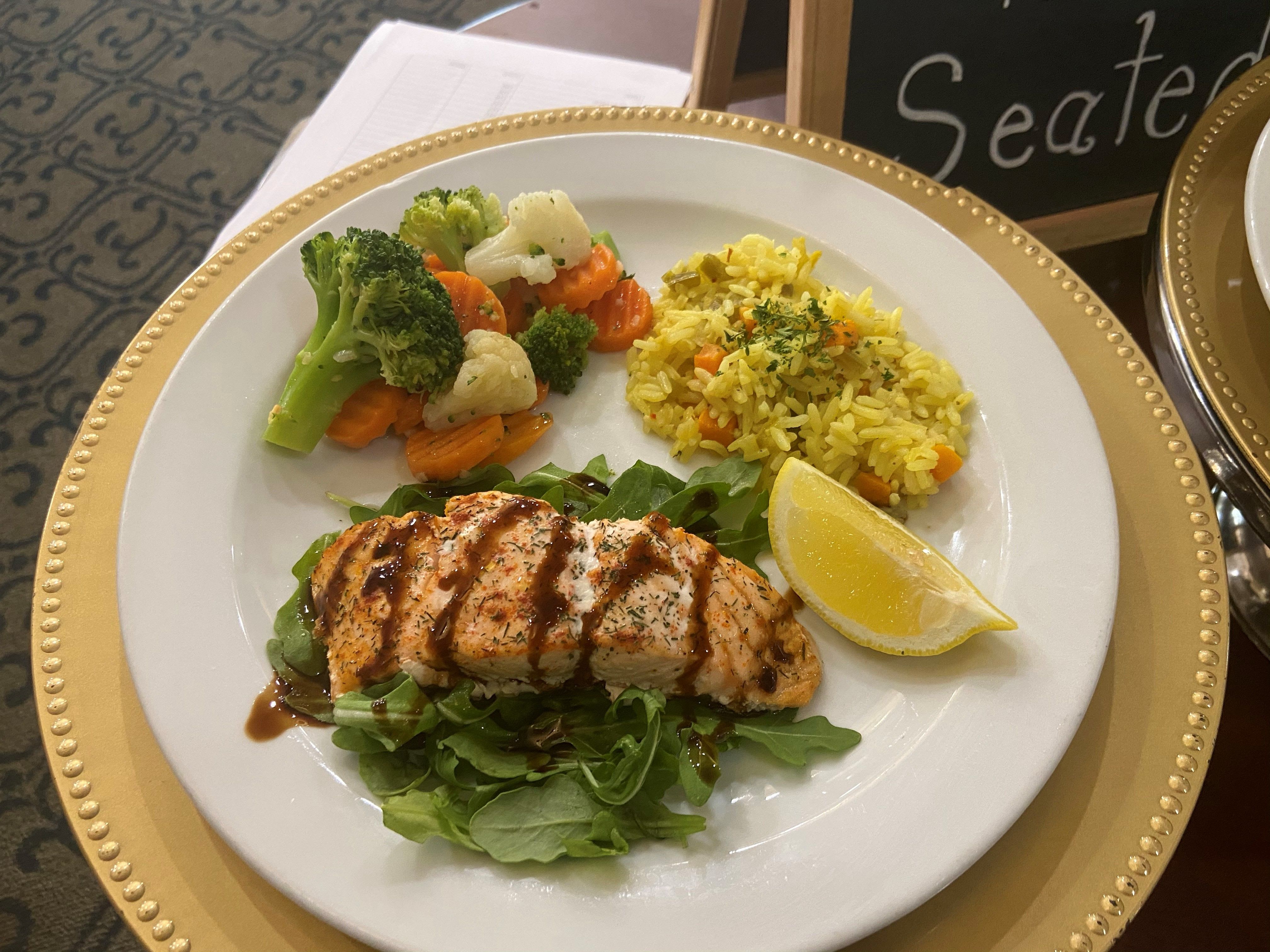 Grilled salmon with saffron rice and a vegetable medley